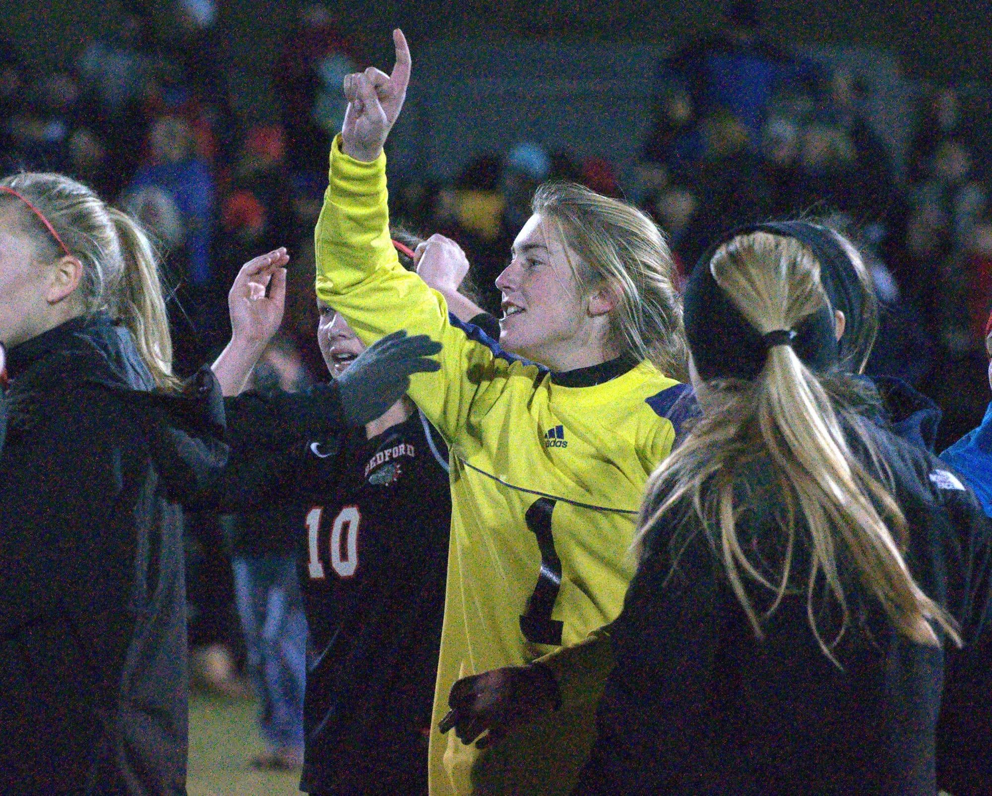 Bedford's Brooke Barrett celebrates with her teammates after the Bulldogs defeated Exeter in the Division I championship.