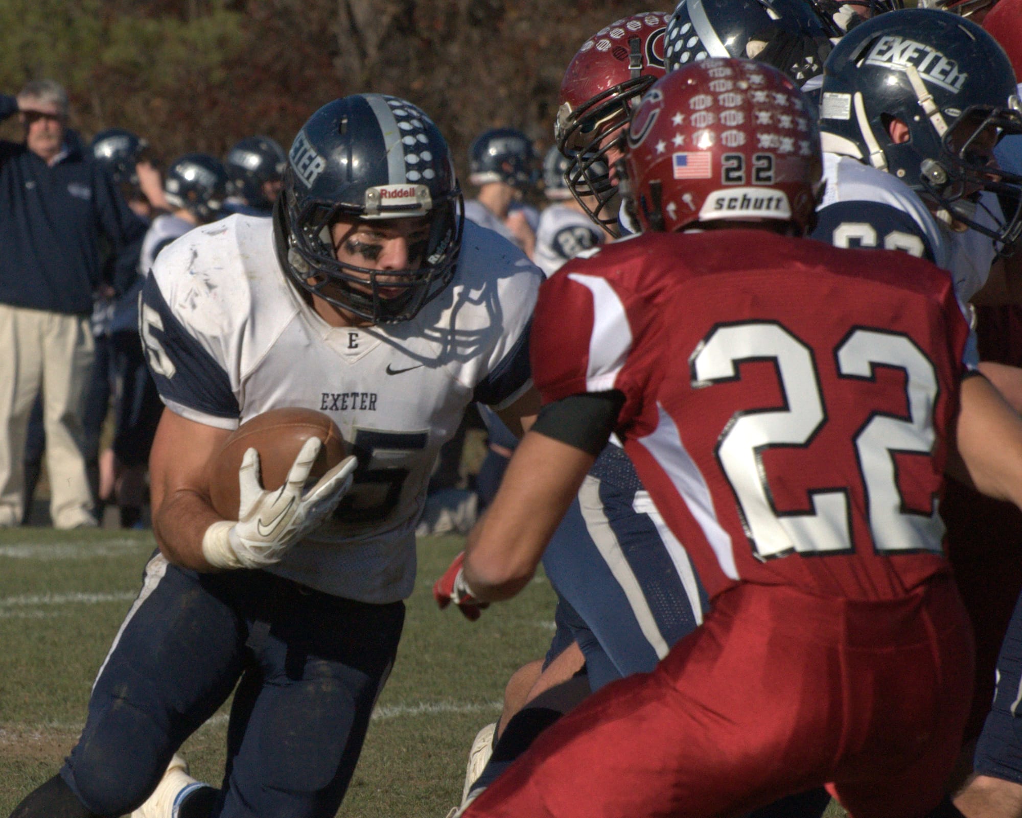 Exeter's Ryan Kelly looks for room to run as Concord's Diego Hebra comes up to make the tackle.