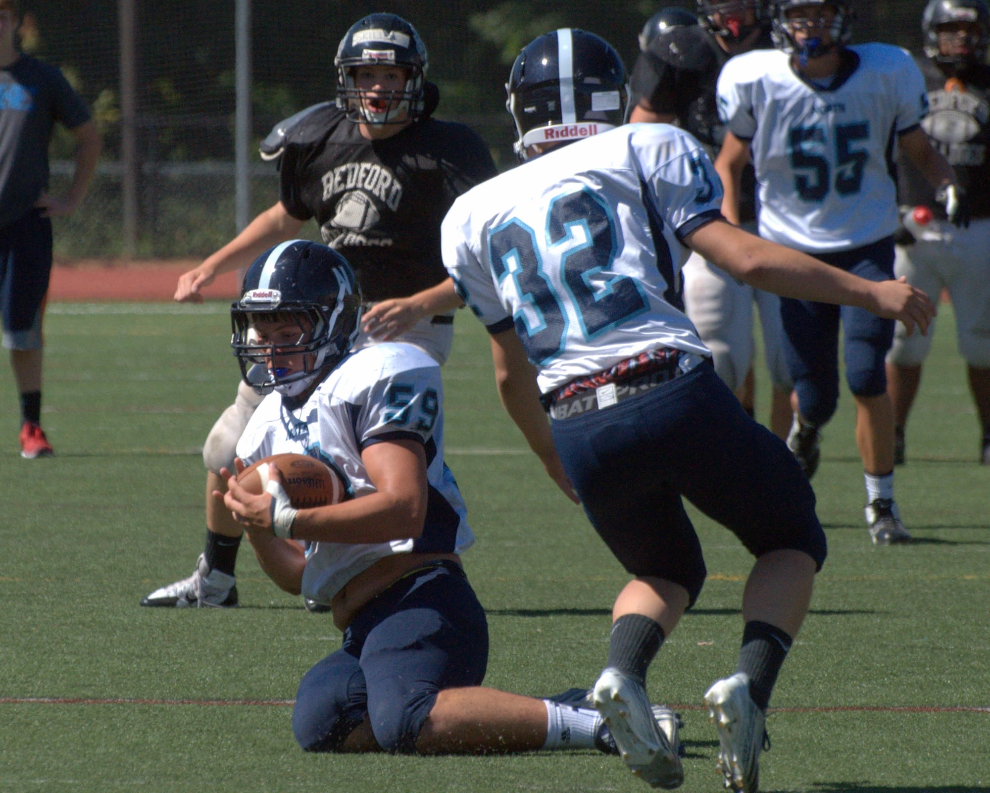 Nashua North's Aaron Stewart (No. 32) watches as teammate Greg Stanton intercepts a pass earlier this year.