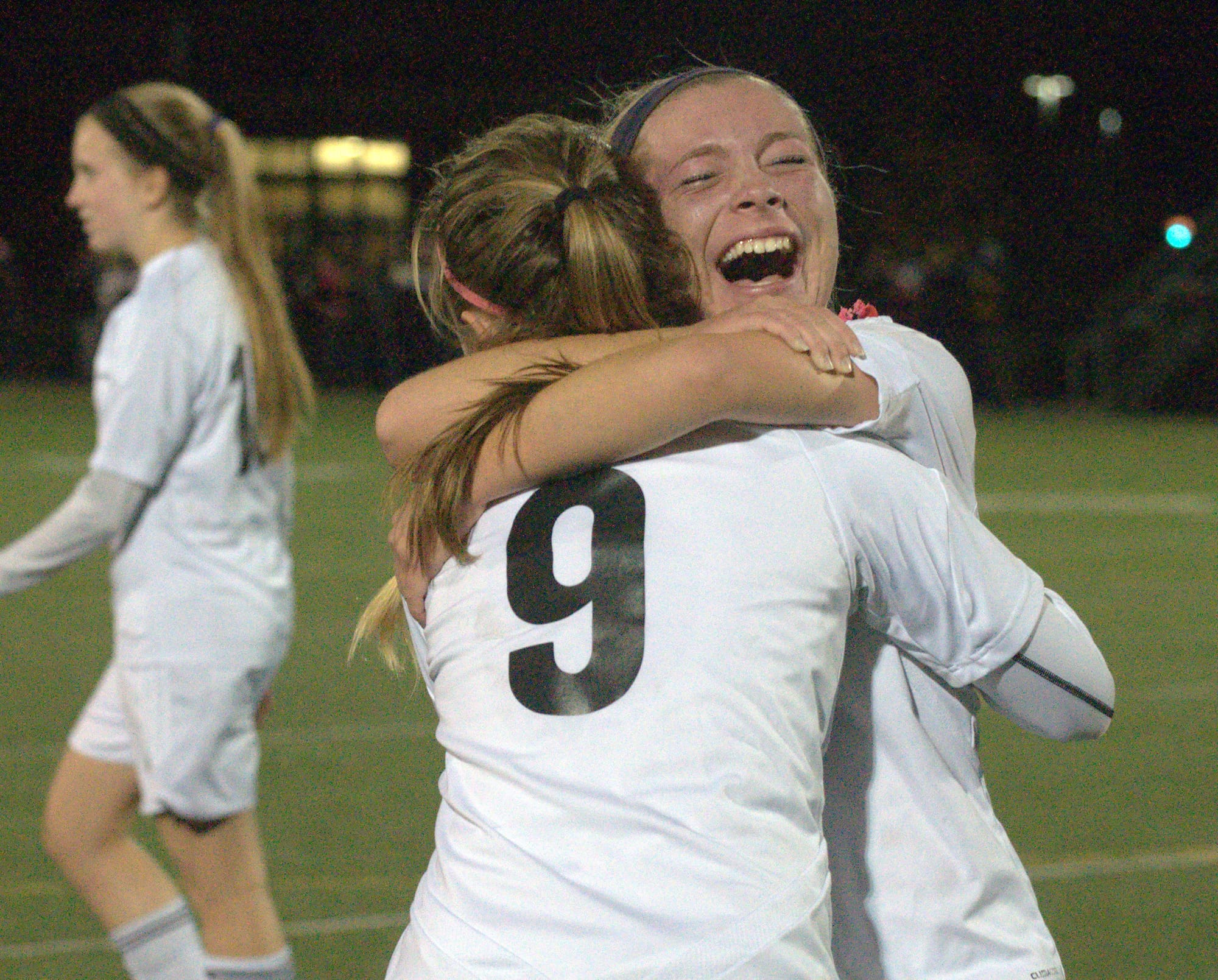 Taylor Behn hugs Rachael Facey after Souhegan's win over Hanover in the Division II semifinals.