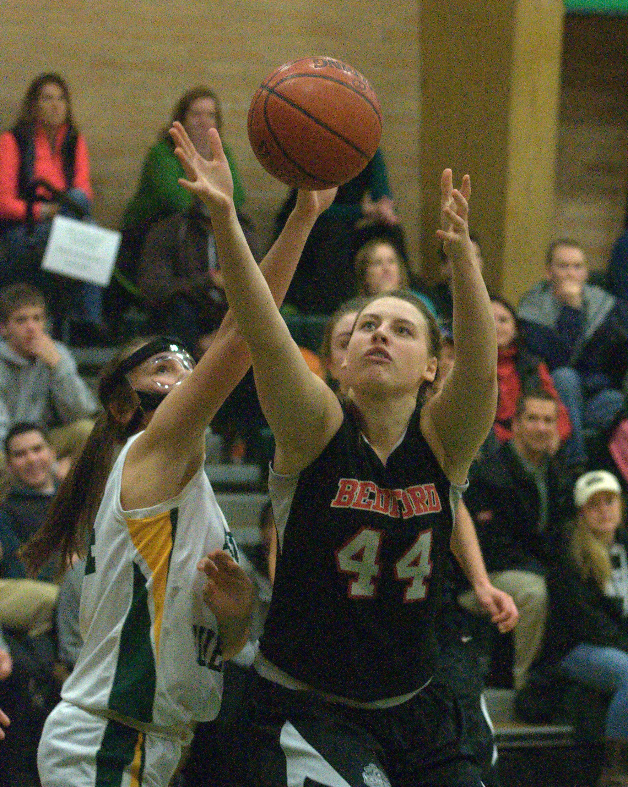 Bedford's McKenzie Brown and Bishop Guertin's Meghan Cramb battle for a rebound during Monday's game.