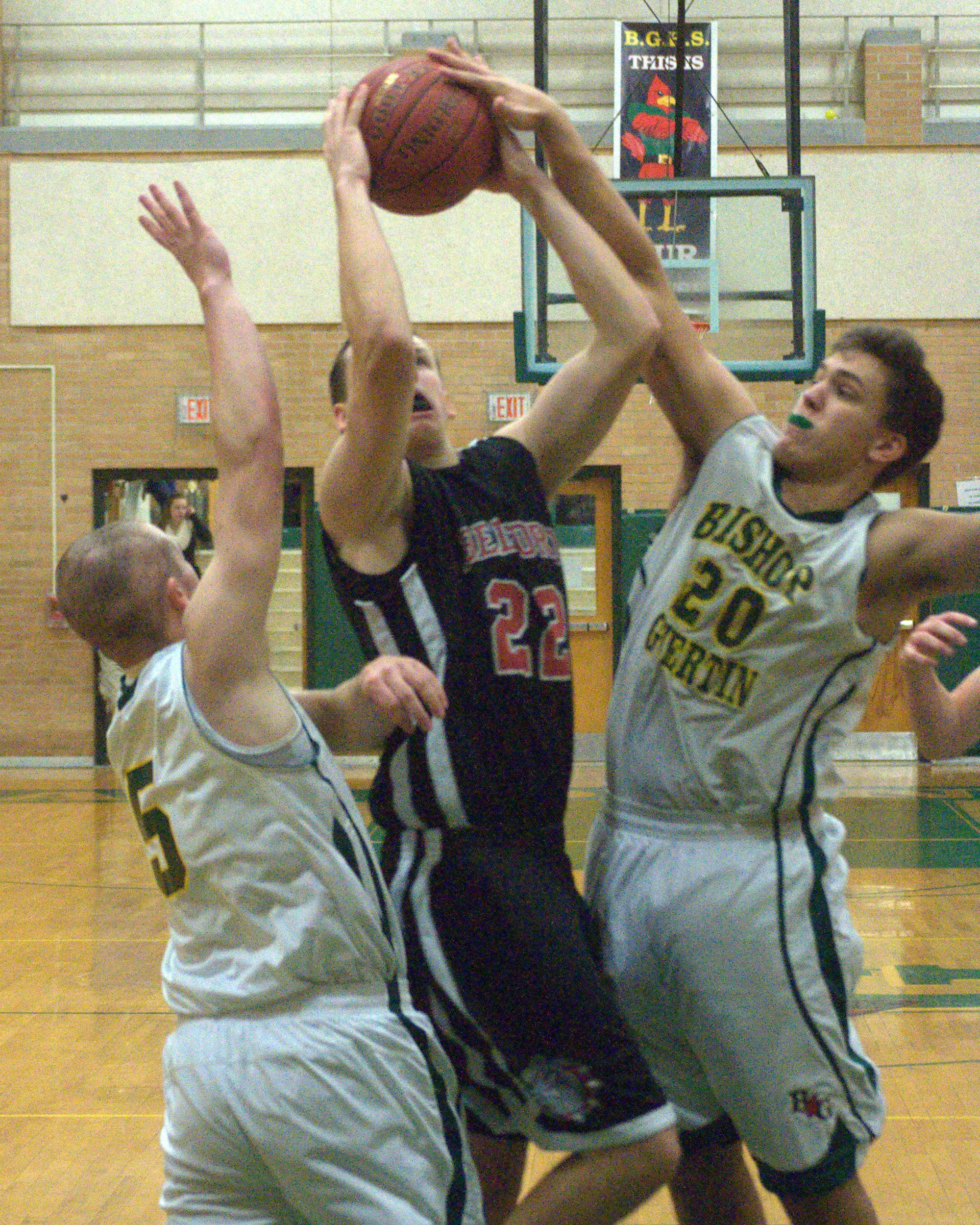 Bishop Guertin's Kyle Lavoie, left, and Costas Niarhos try to keep Bedford's Ryan Brown from scoring during Monday's game.