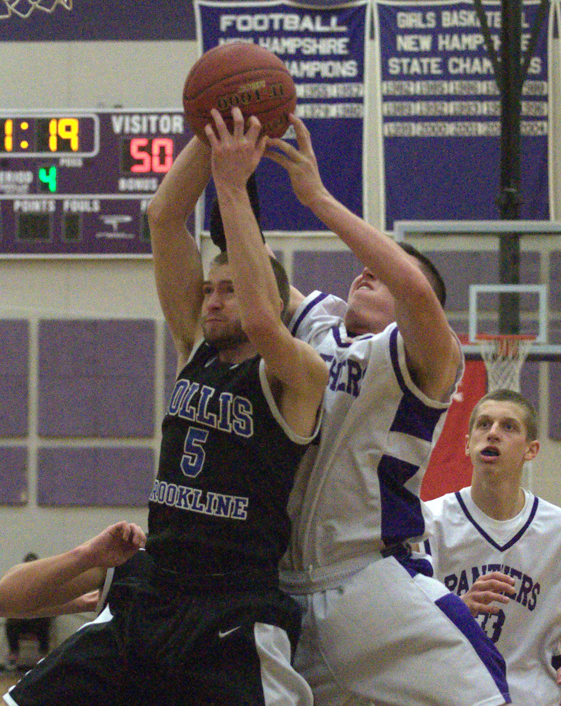 Hollis Brookline's Cole Gallant and Nashua South's Trevor Knight battle for a rebound during Thursday's game.