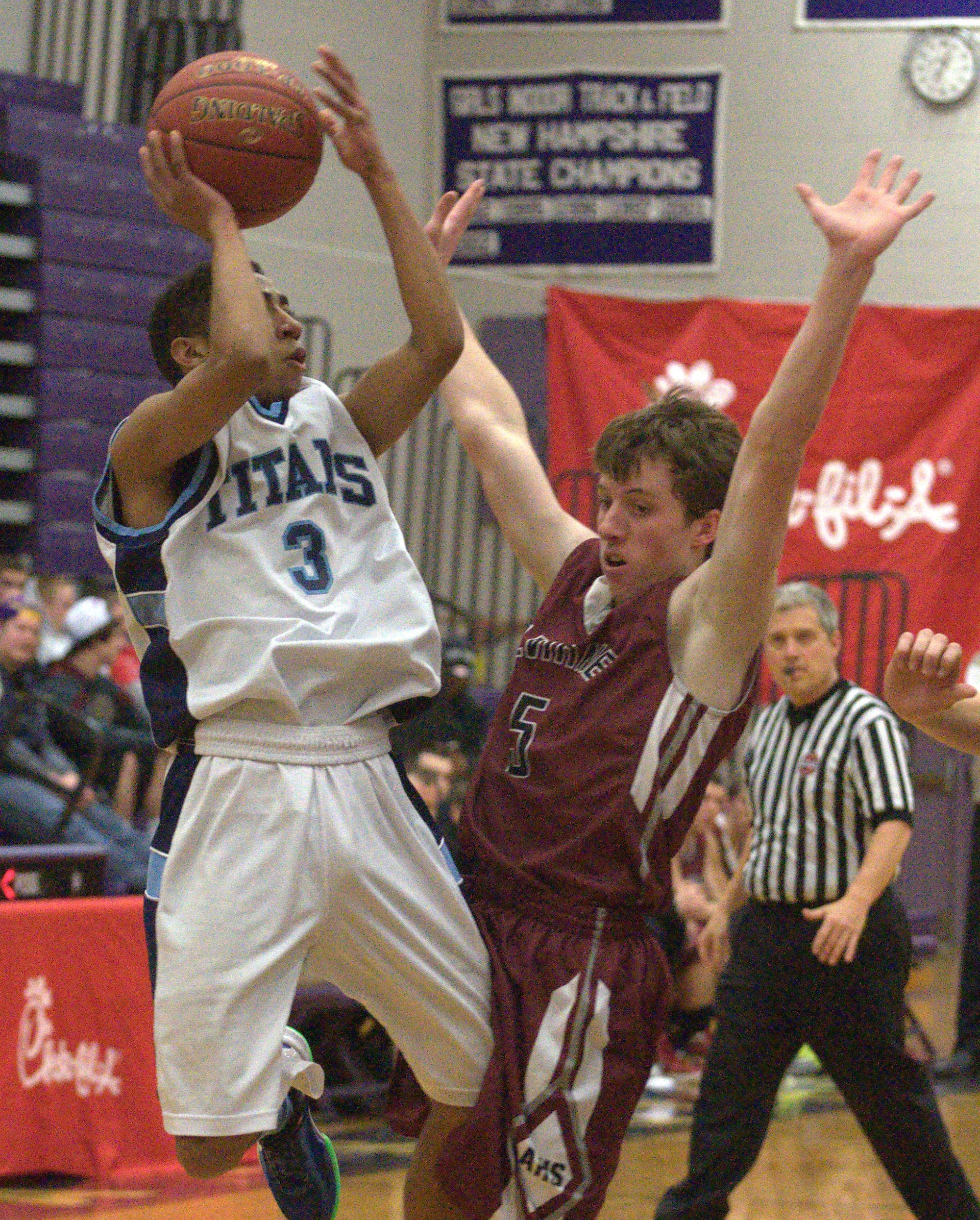 Alvirne's George Notini defends as Nashua North's Jordan Lates goes up for a shot during Thursday's game.