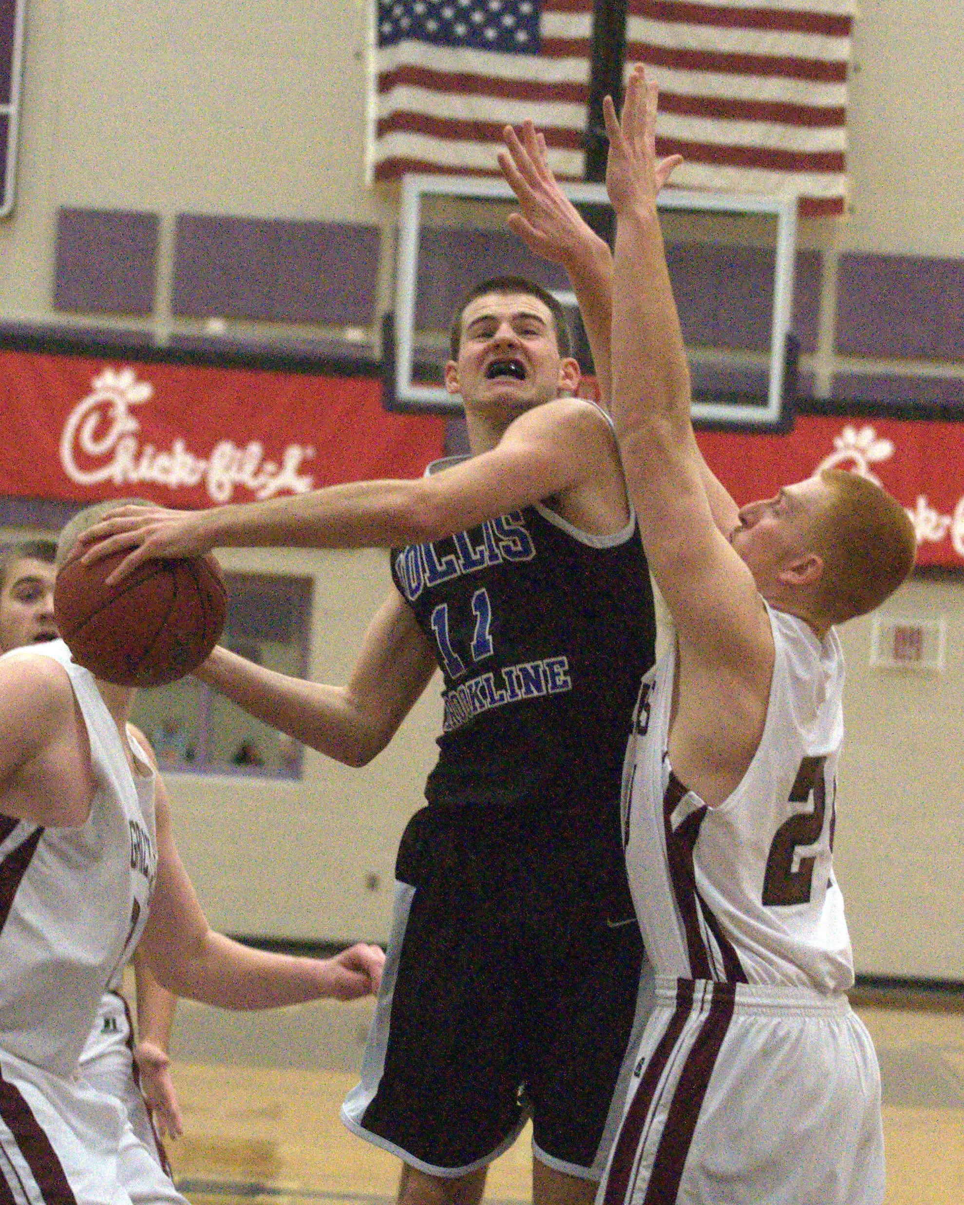 Hollis Brookline's Logan Blake drives to the basket against Goffstown's Patrick Kelsey during Friday's game.