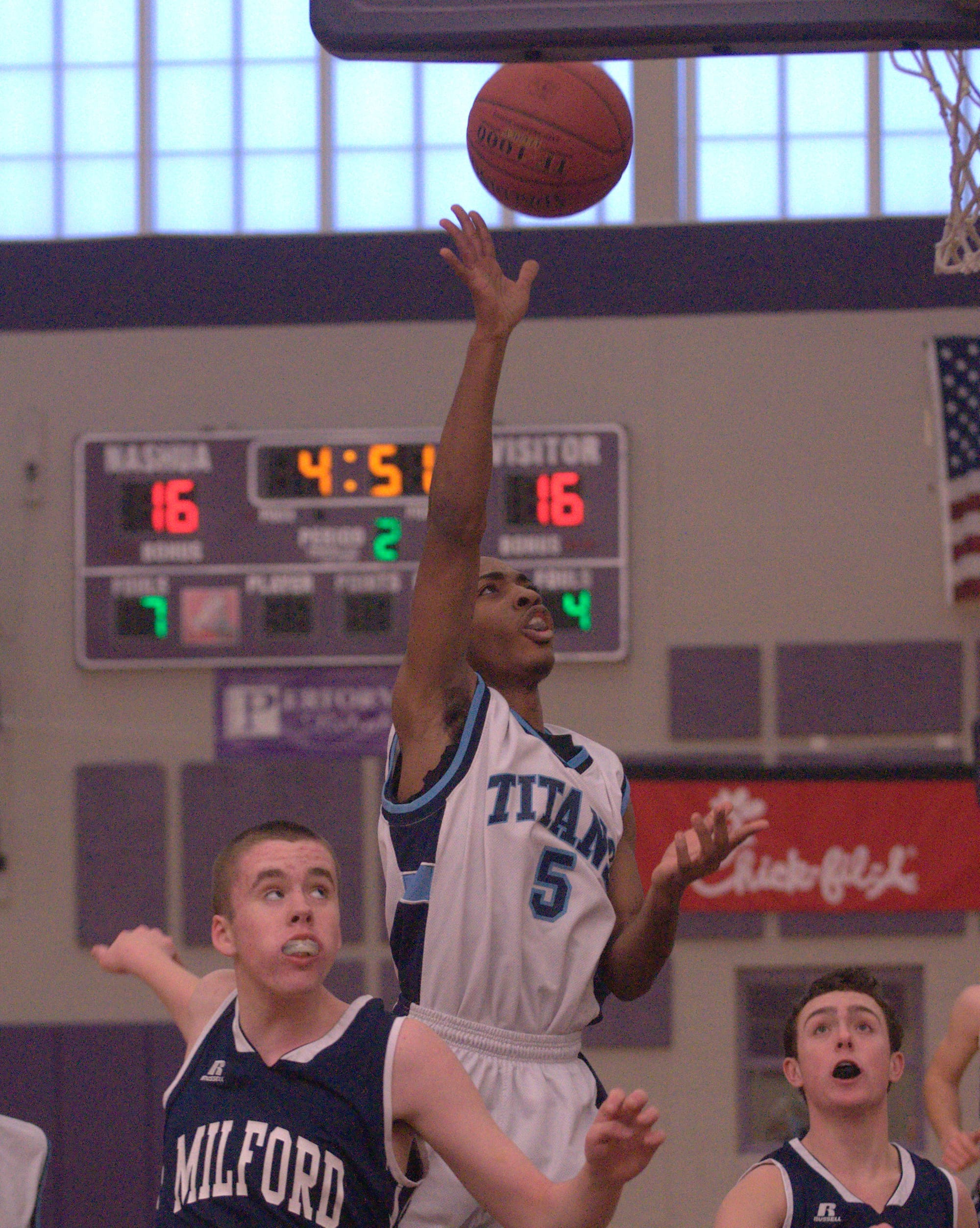 Nashua North's Ashea Bittle puts up a shot as Milford's Dan Murray, left, and Drew Jepson look on during Friday's game.