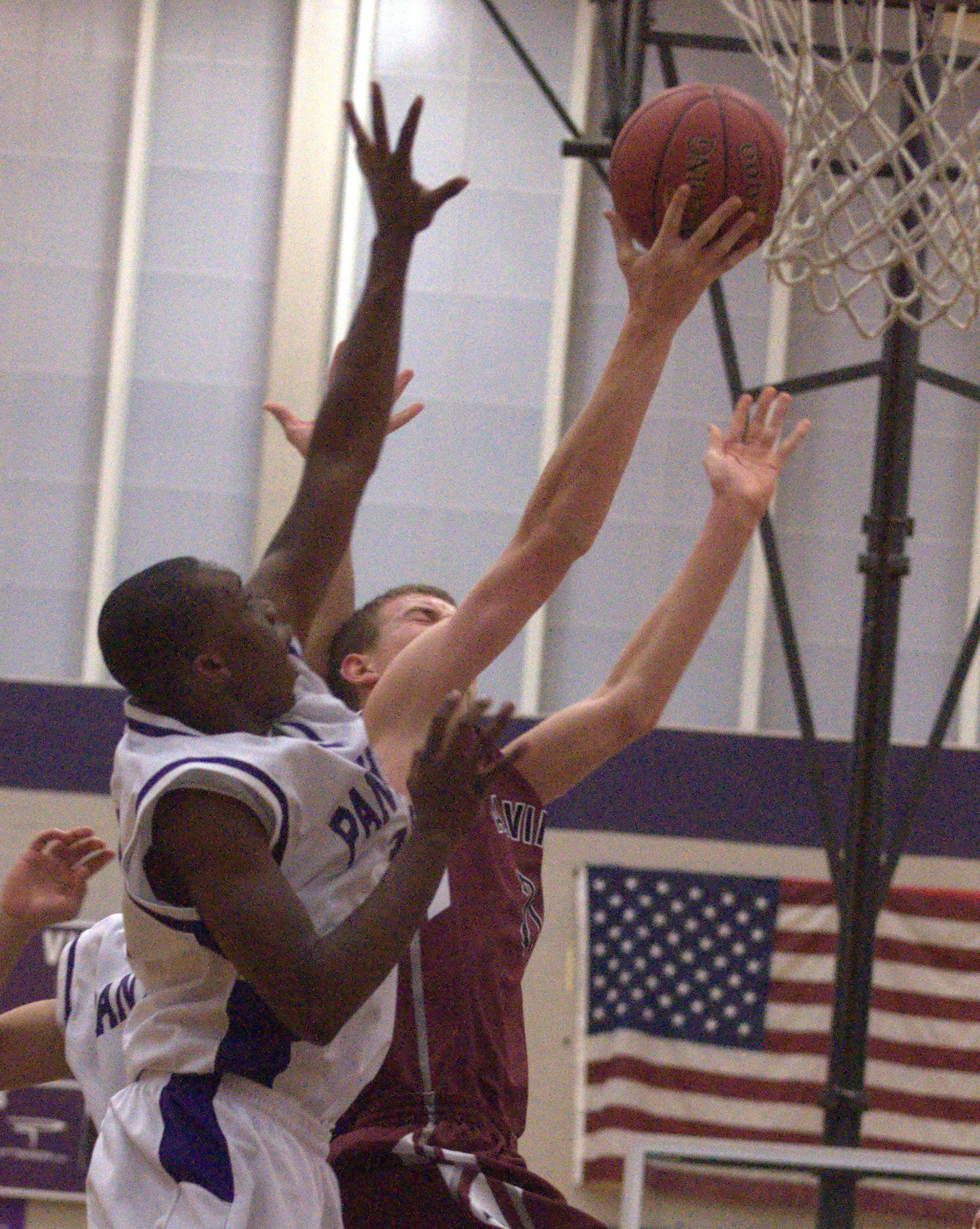Nashua South's Malik Langa tries to block a shot by Alvirne's Tyler Brown.