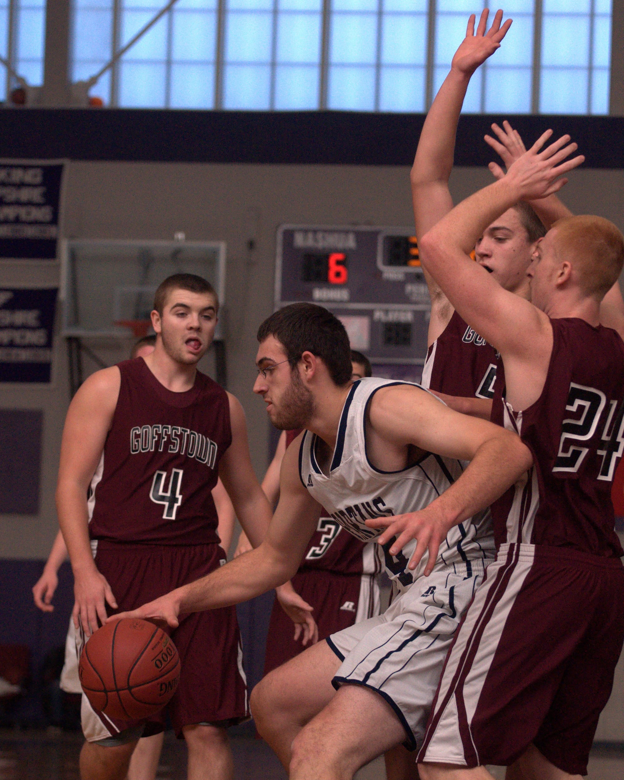Milford's Seth Hopkins gets double teamed by Goffstown's Patrick Kelsey (No. 24) and Tim Comeau during Saturday's game.