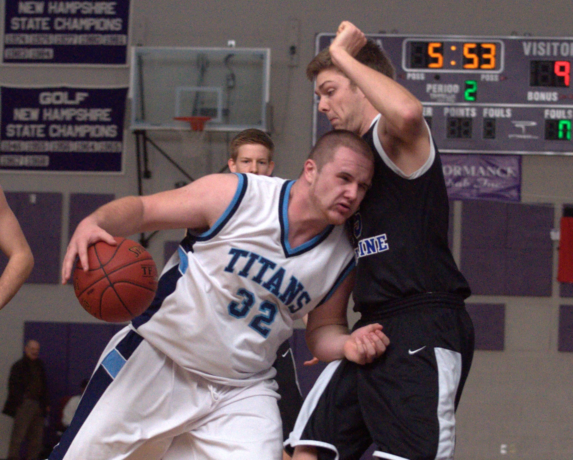 Nashua North's Matt LaVallee runs into Hollis Brookline's Shea Whalen as he tries to get to the basket during Saturday's game.