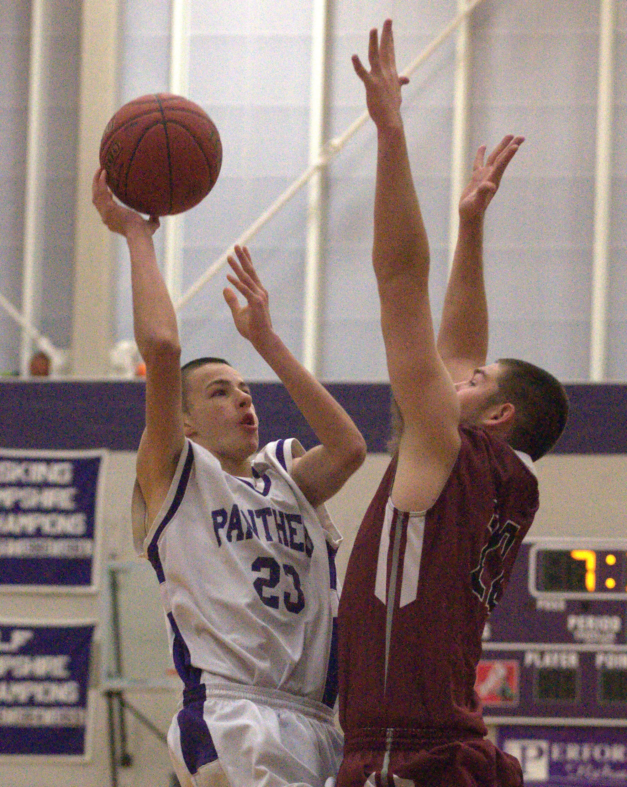 Nashua South's D.J. Frechette goes in for a layup as Alvirne's Alex Wetmore defends during Saturday's game.