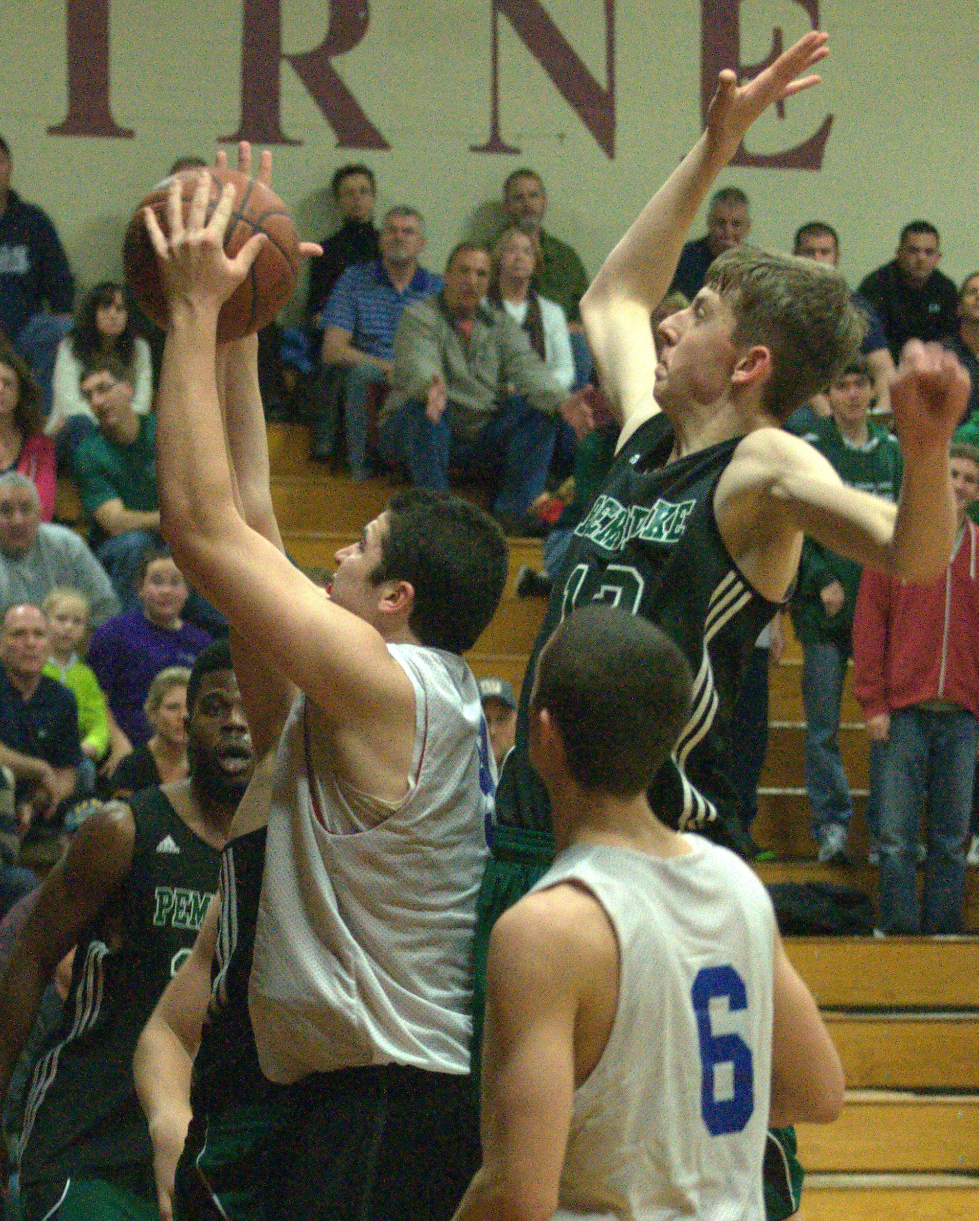 Pembroke's Max Curran gets ready to block a shot by Trinity's Connor Walsh.