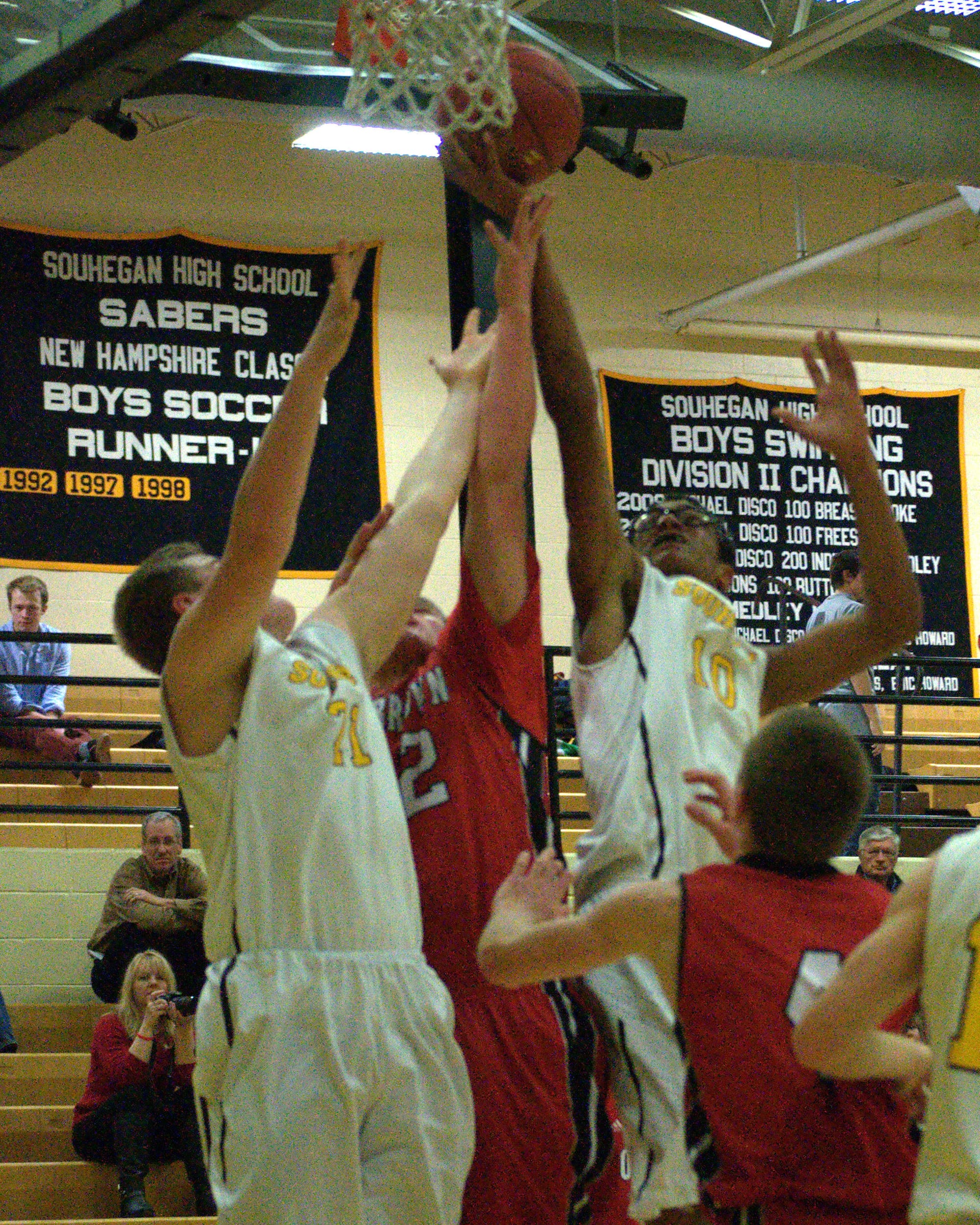 Souhegan's Jerrell Duguay Webster and Charlie Driscoll battle for a rebound with Coe-Brown's Luke Zollman.