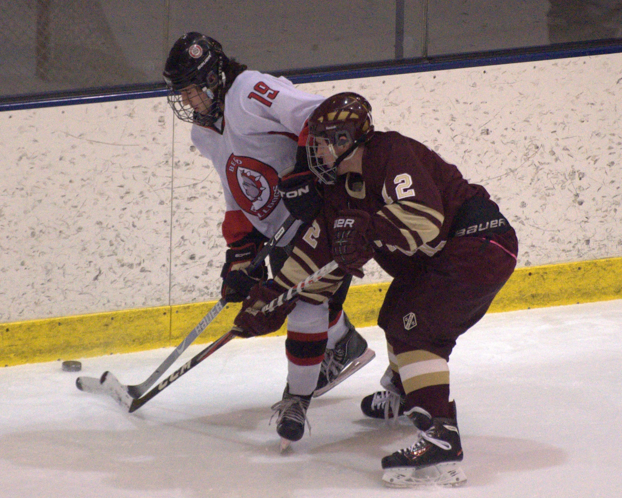 Alvirne's Patrick DeVito tries to knock the puck away from Bedford's Neil Soucy during Saturday's game.