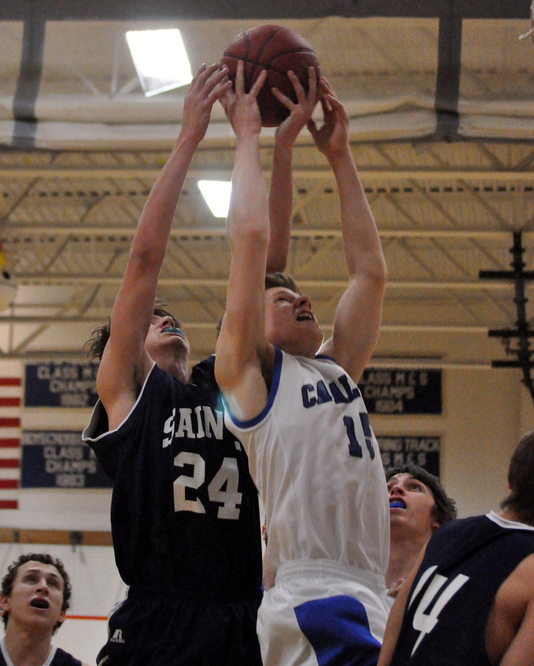 St. Thomas' Ian Wilson and Hollis Brookline's Daniel Bentall battle for a rebound during Tuesday's game.