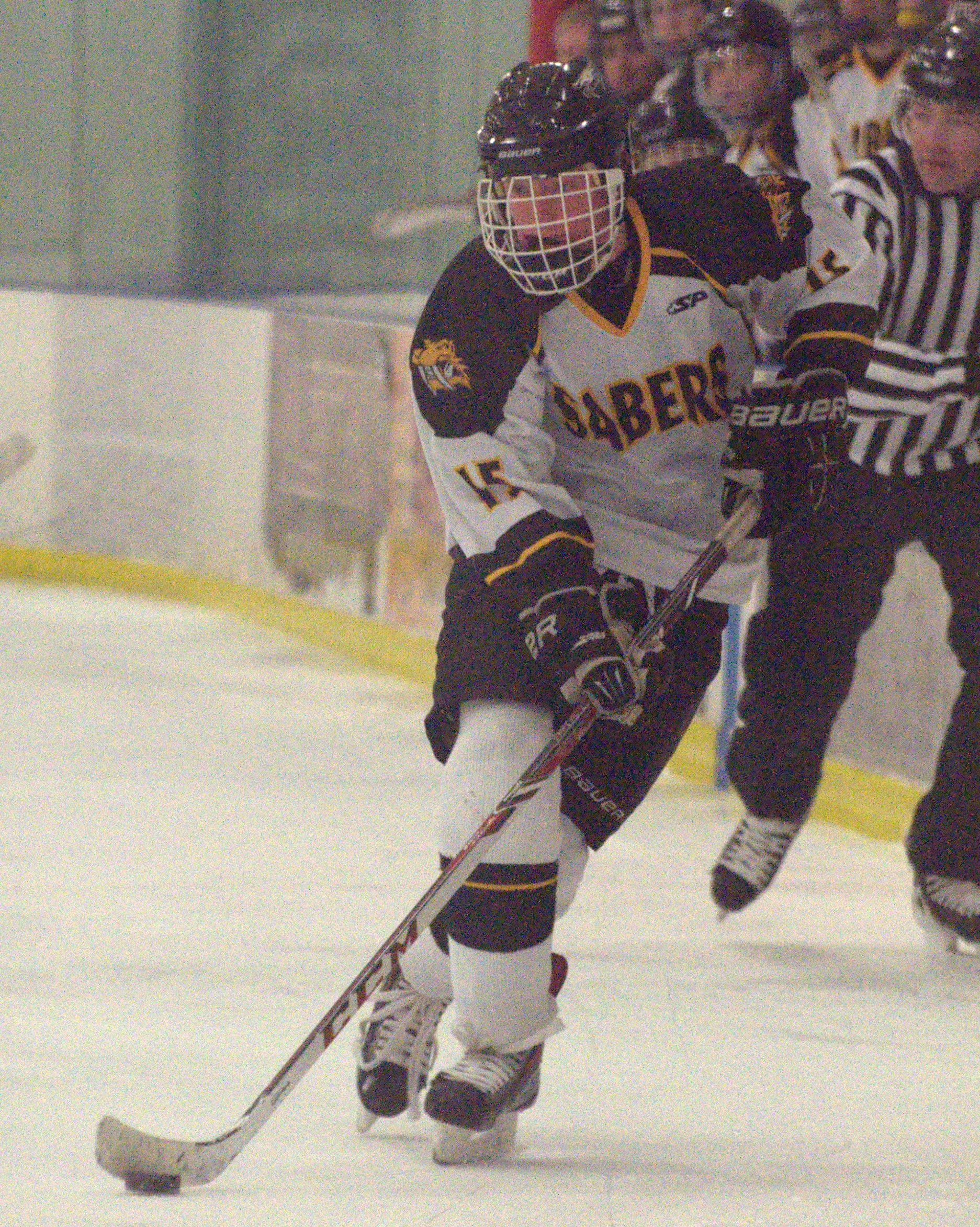Souhegan's Joe Nutting skates with the puck.