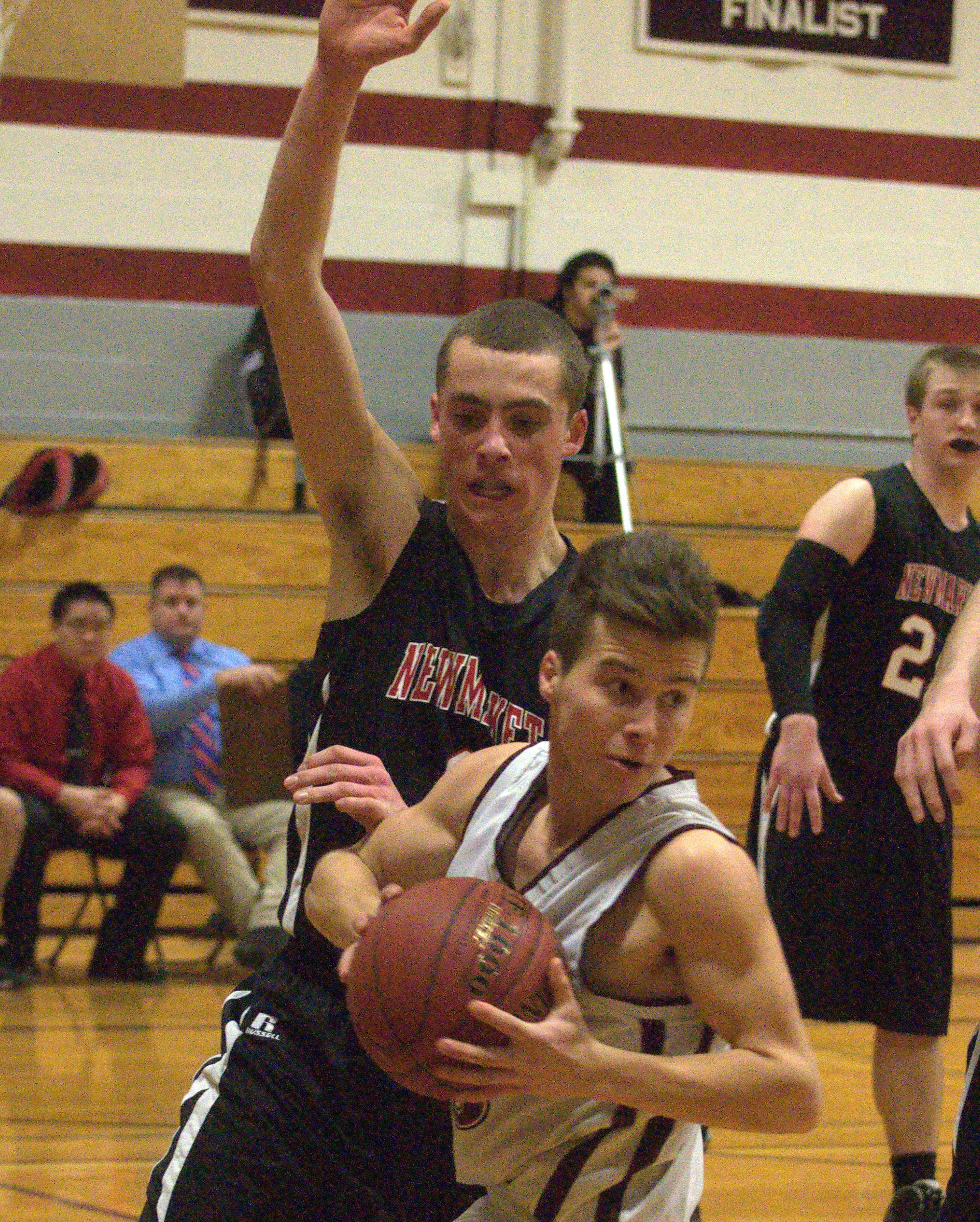Newmarket's Sam Leahy defends against Wilton-Lyndeborough's James Edmunds.