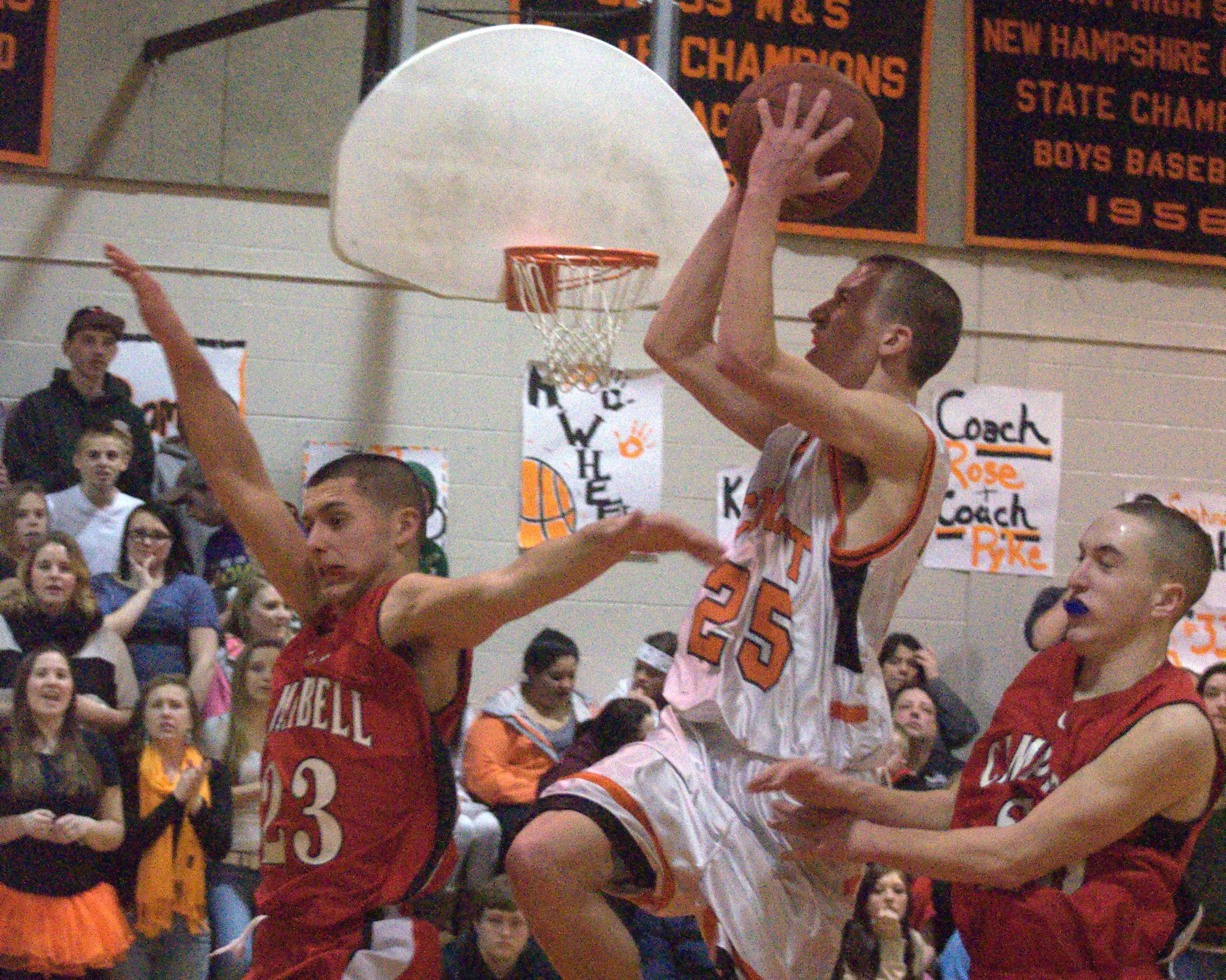 Conant's Robert O'Brien splits two defenders as he goes in for a layup.