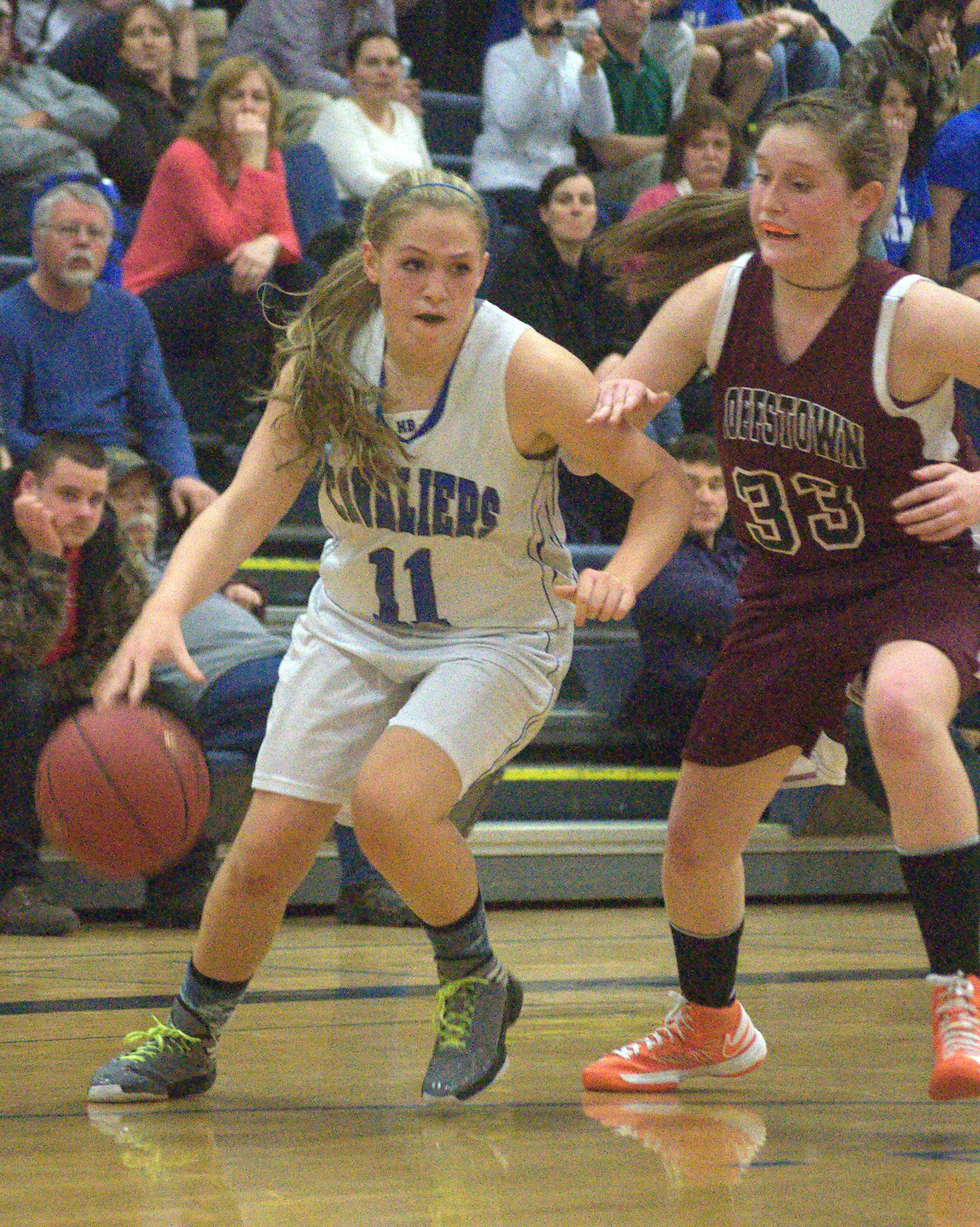 Goffstown's Kathryn Howe tries to slow down Hollis Brookline's Bri Hackett during Friday's game.
