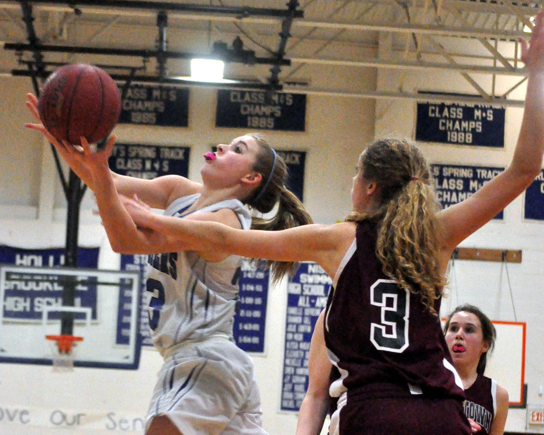 Hollis Brookline's Cassandra Stapelfeld drives to the basket as Goffstown's Cassidy Lalumiere defends during Friday's game.