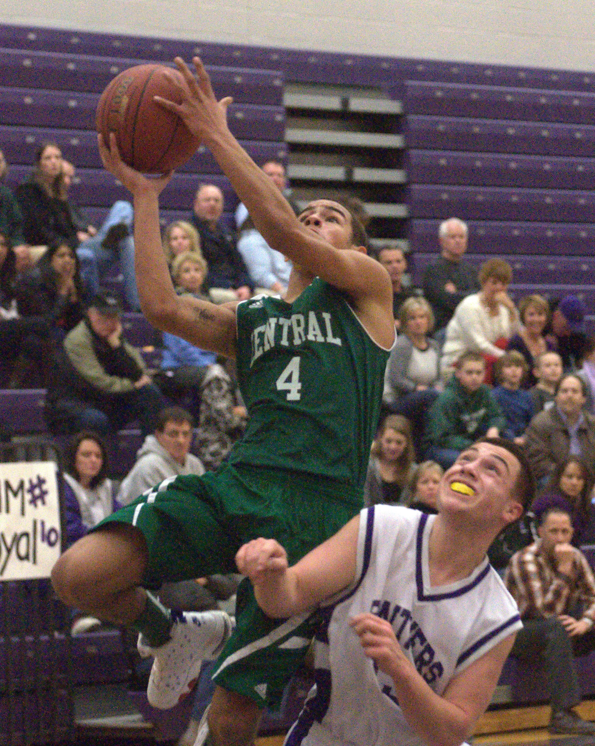 Manchester Central's Nate Guillermo goes in for a layup over Nashua South's Ben Seegel during Tuesday's game.