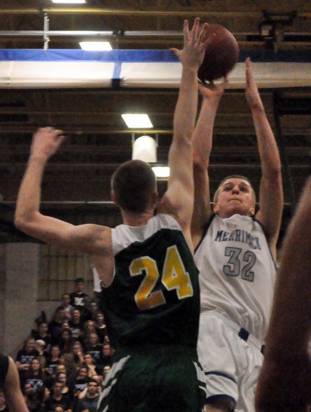 Merrimack's Eric Gendron puts up a shot over Bishop Guertin's Andrew Williams during Tuesday's game.
