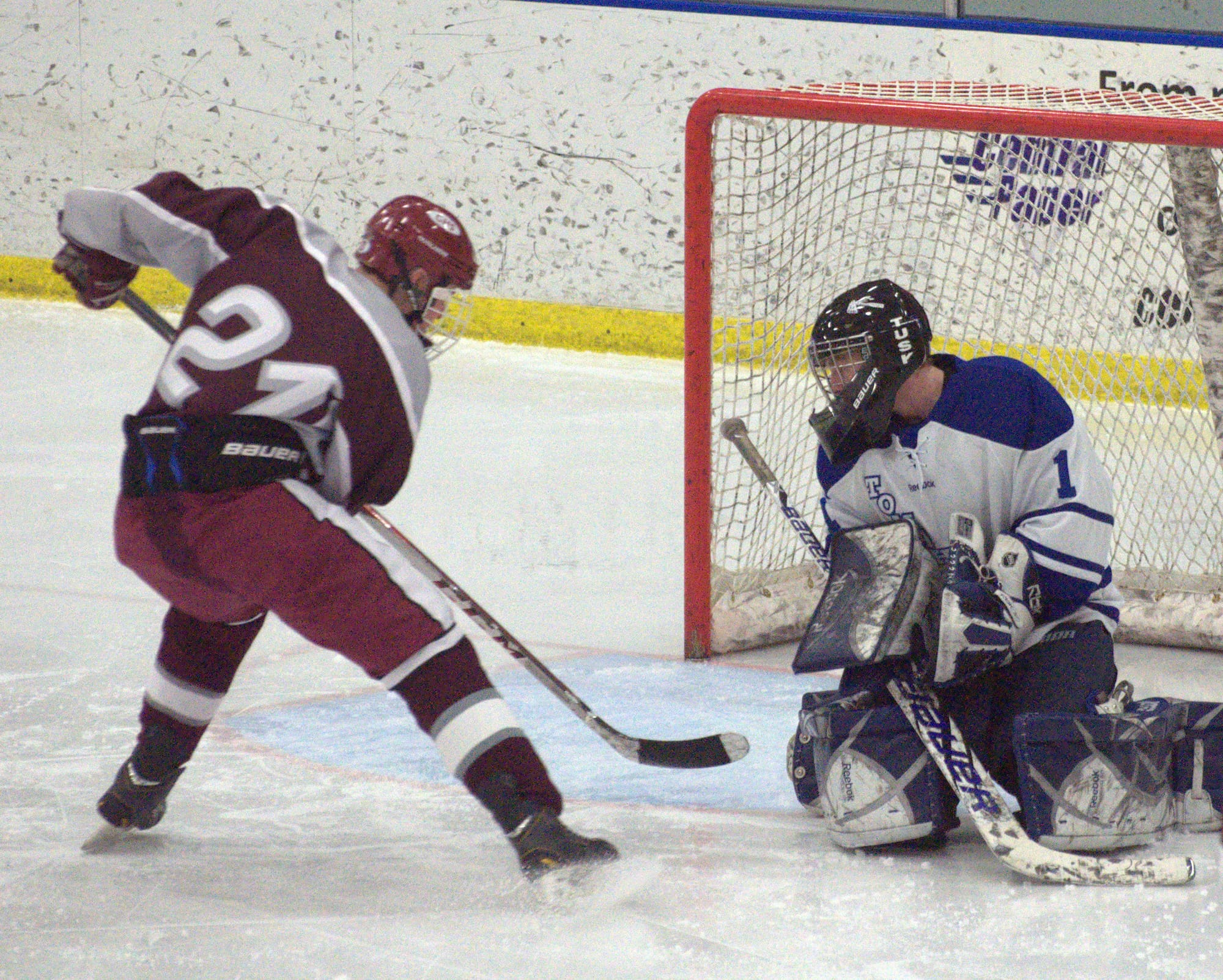 Merrimack's Devin Gillis makes a save as Goffstown's A.J. Potvin looks to poke the puck free during Monday's game.