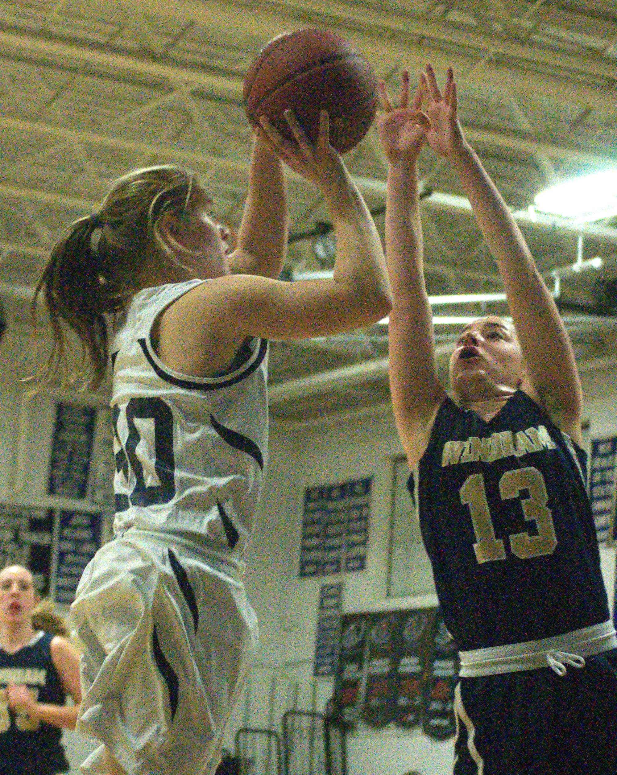 Windham's Clairee Putnam tries to block a shot by Milford's Erin McGuire during Tuesday's game.