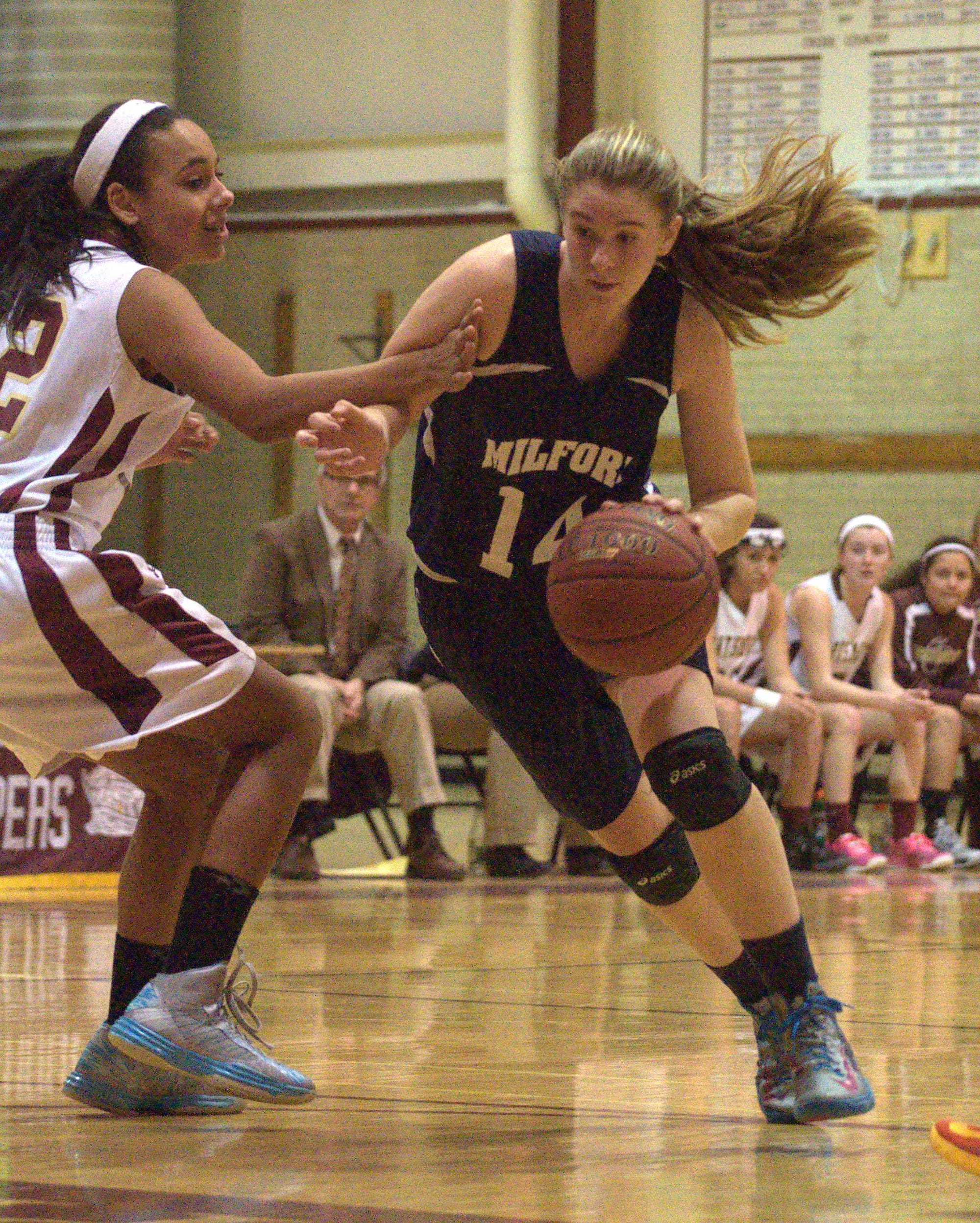 Milford's Jessica Ryan drives to the basket.