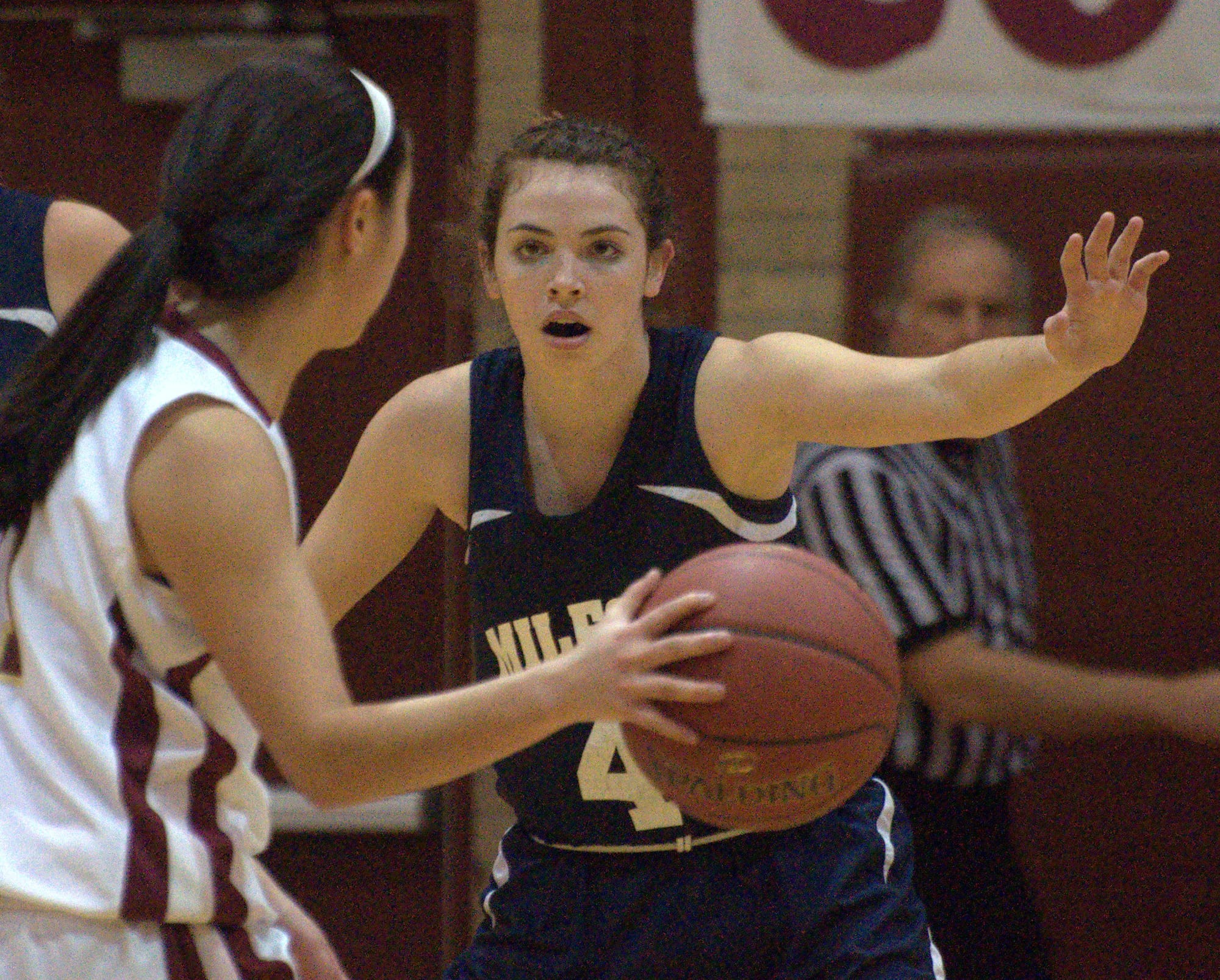 Milford's Adelle Pitsas plays defense against Portsmouth's Tighe Loch during Thursday's game.