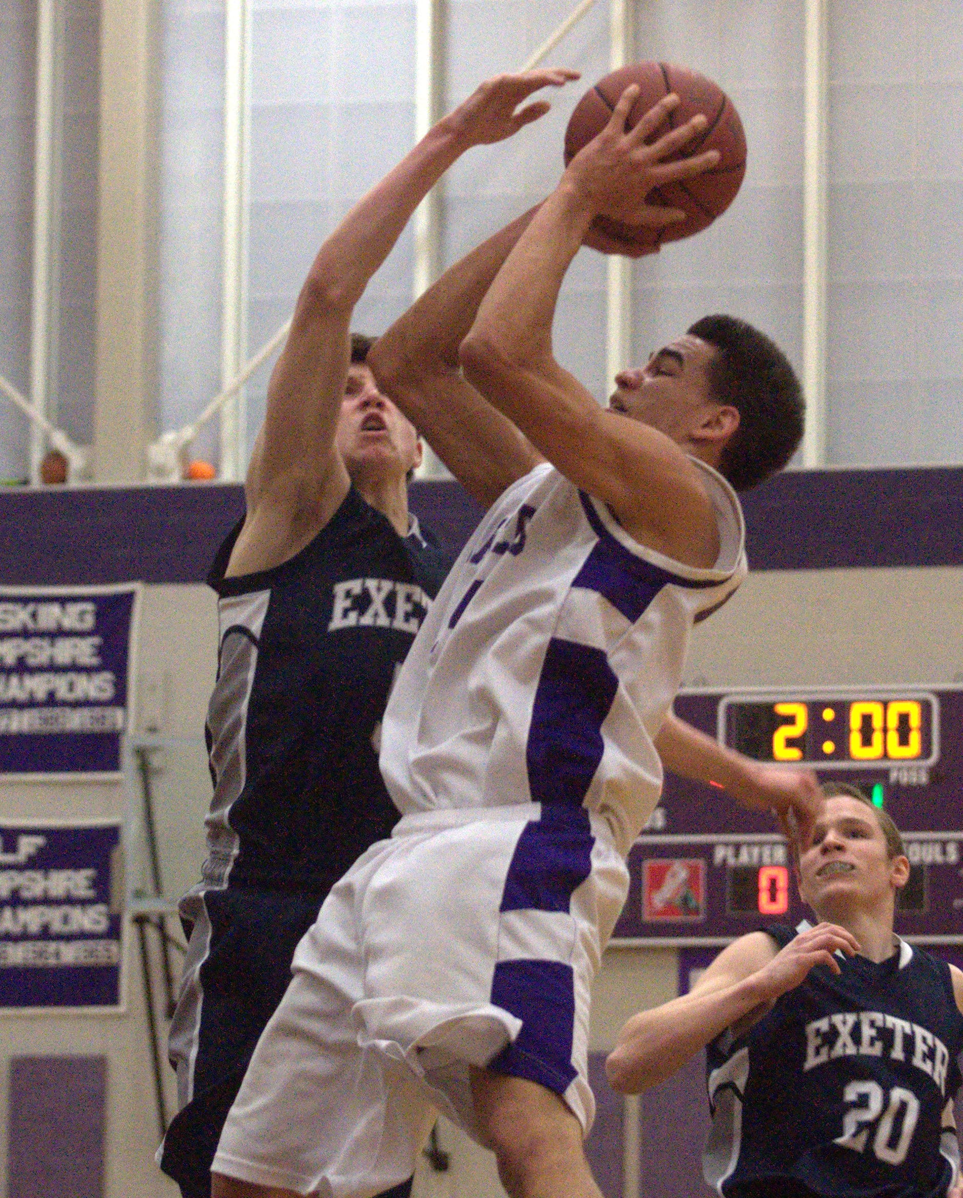 Exeter's Ben Swett tries to block a shot by Nashua South's Yordy Tavarez.