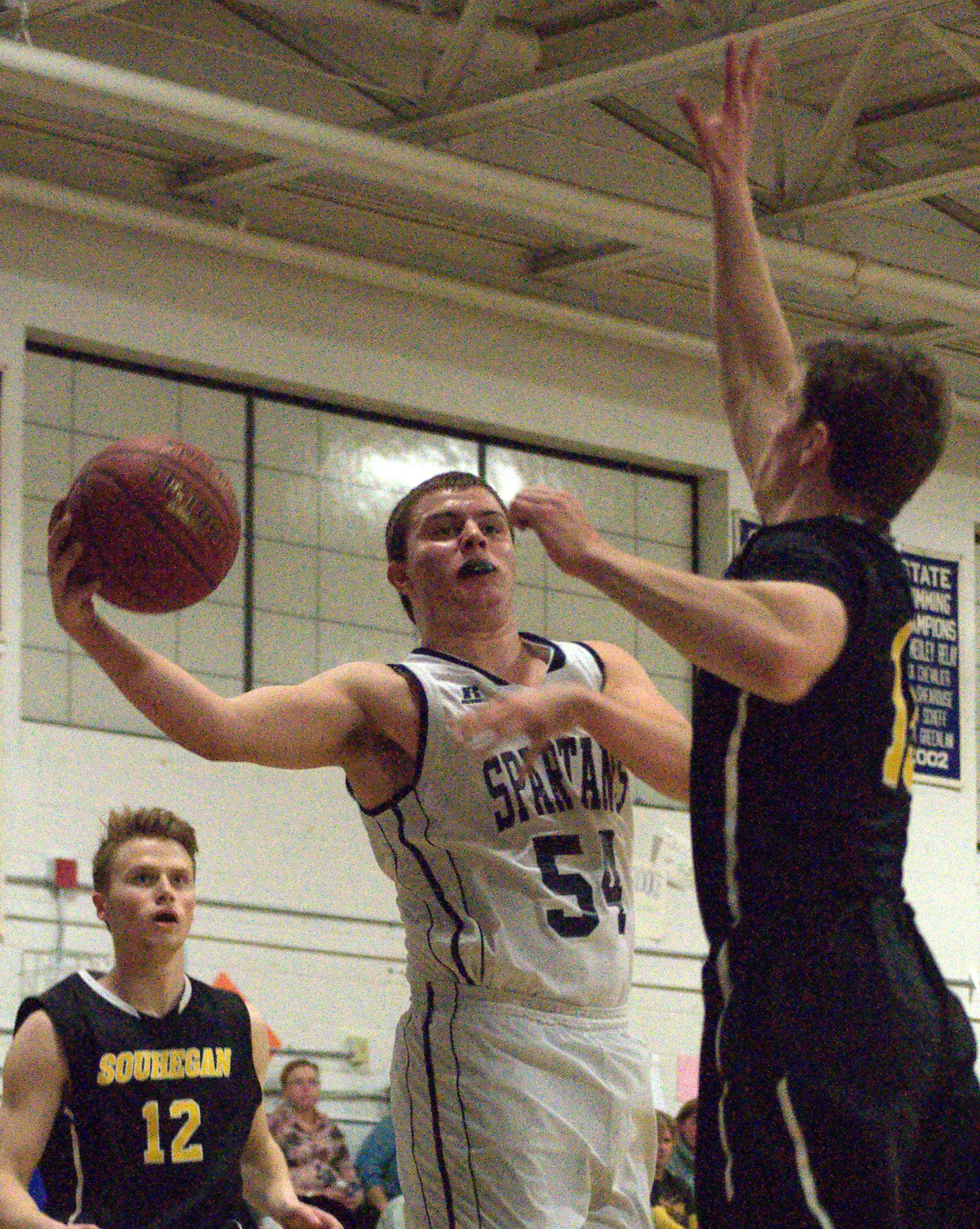 Milford's Connor Gosselin drives to the basket as Souhegan's Isaac Nevrla tries to defend during Thursday's game.