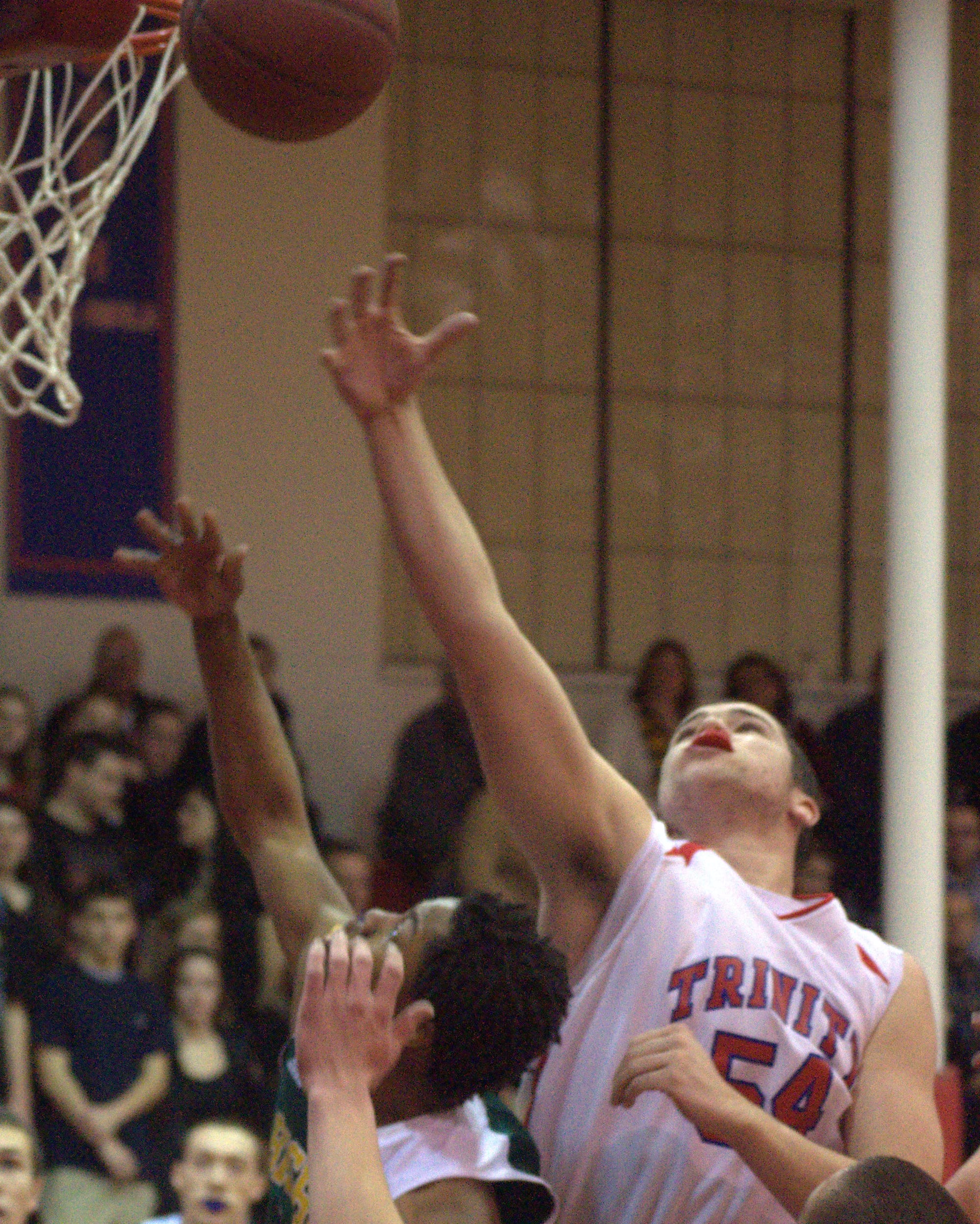 Trinity's Connor Walsh tries to block a shot by Bishop Guertin's C.J. Boykin.