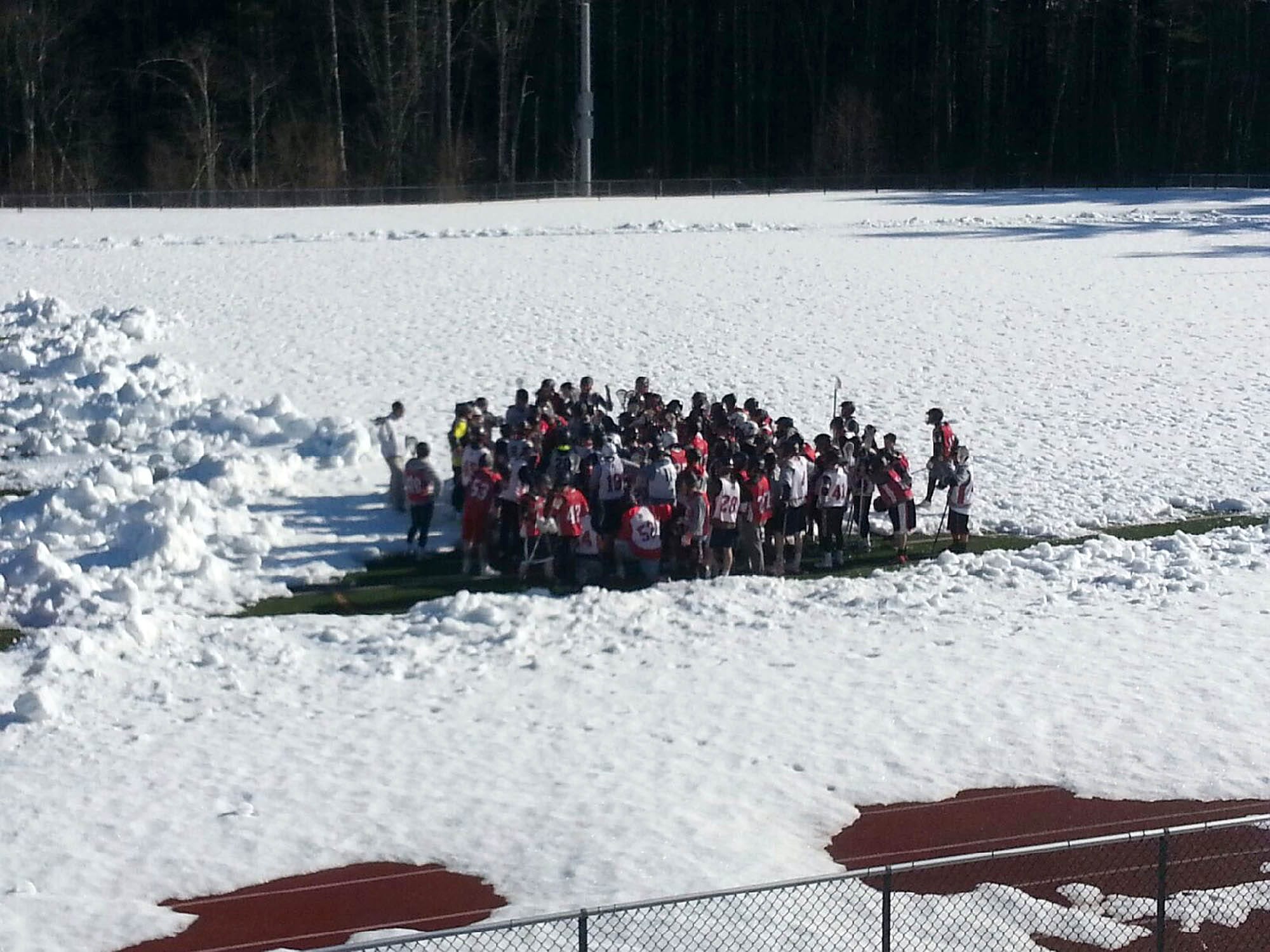 The Bedford boys lacrosse team stands on its field after finishing practice Monday.