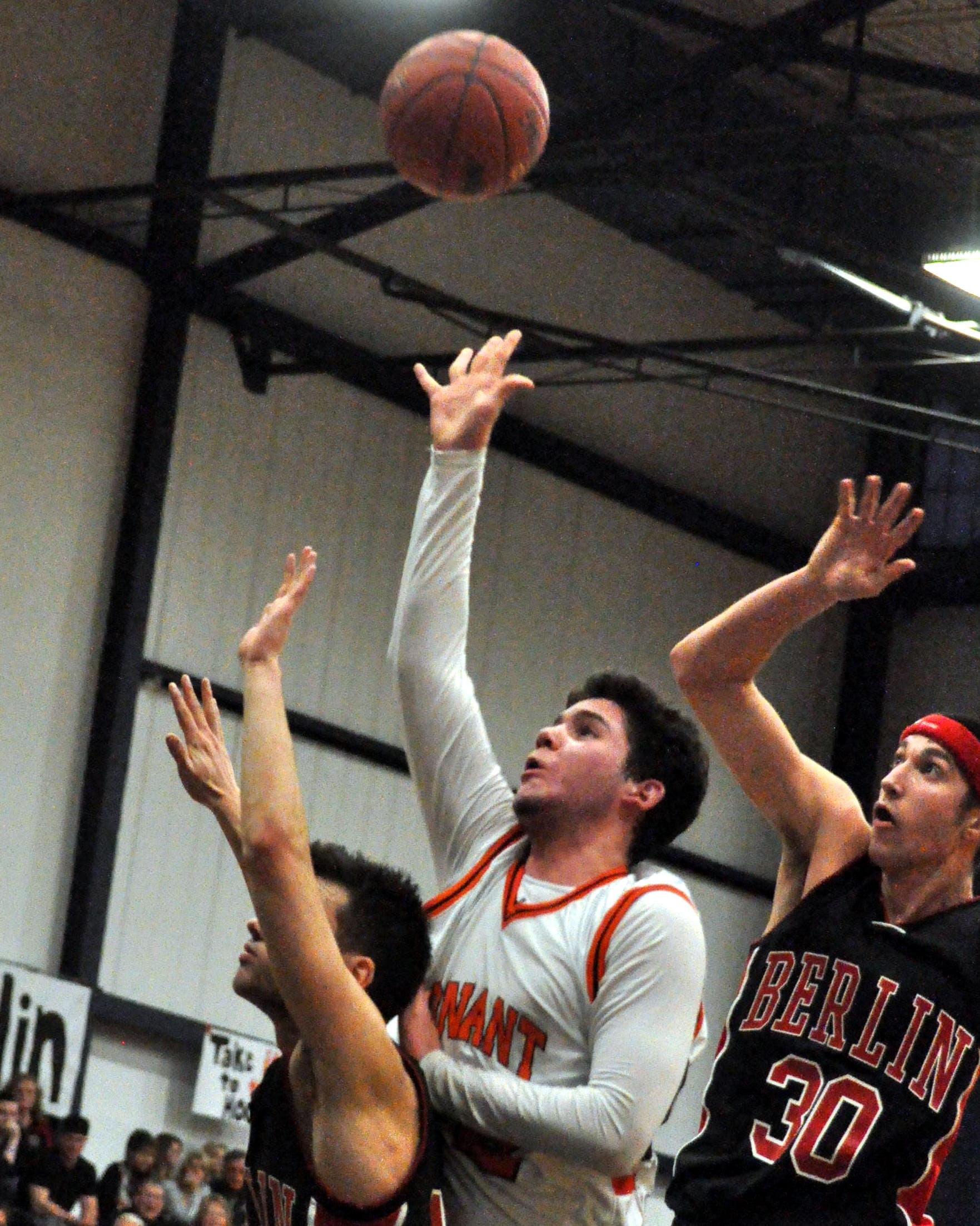 Conant's Eli Hodgson throws up a shot as Berlin's Nick Fodor defends.