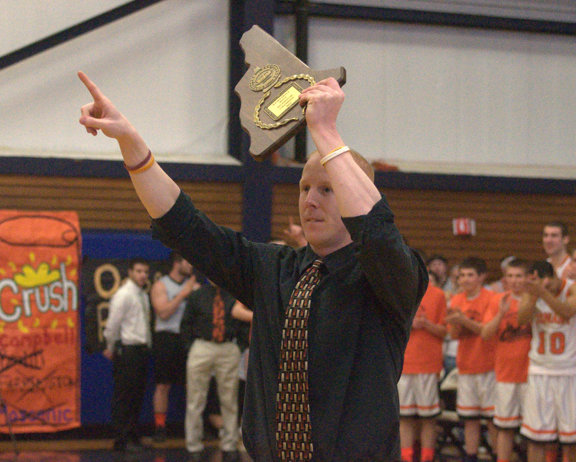 Eric Saucier acknowledges the Conant crowd after accepting the Division III championship plaque Sunday after the Orioles defeated Campbell.