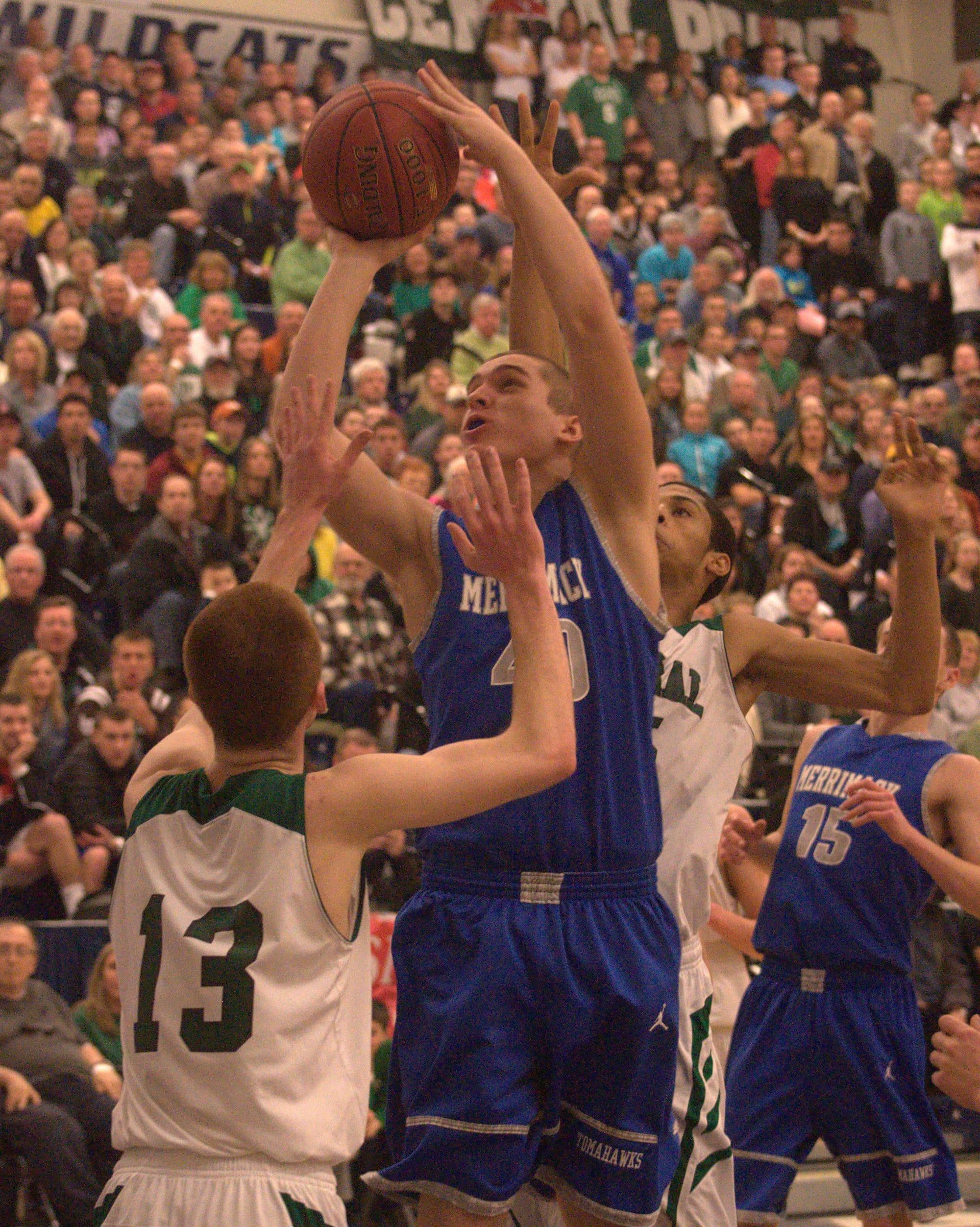 Merrimack's Ian Roberts goes up between a group of Manchester Central defenders.
