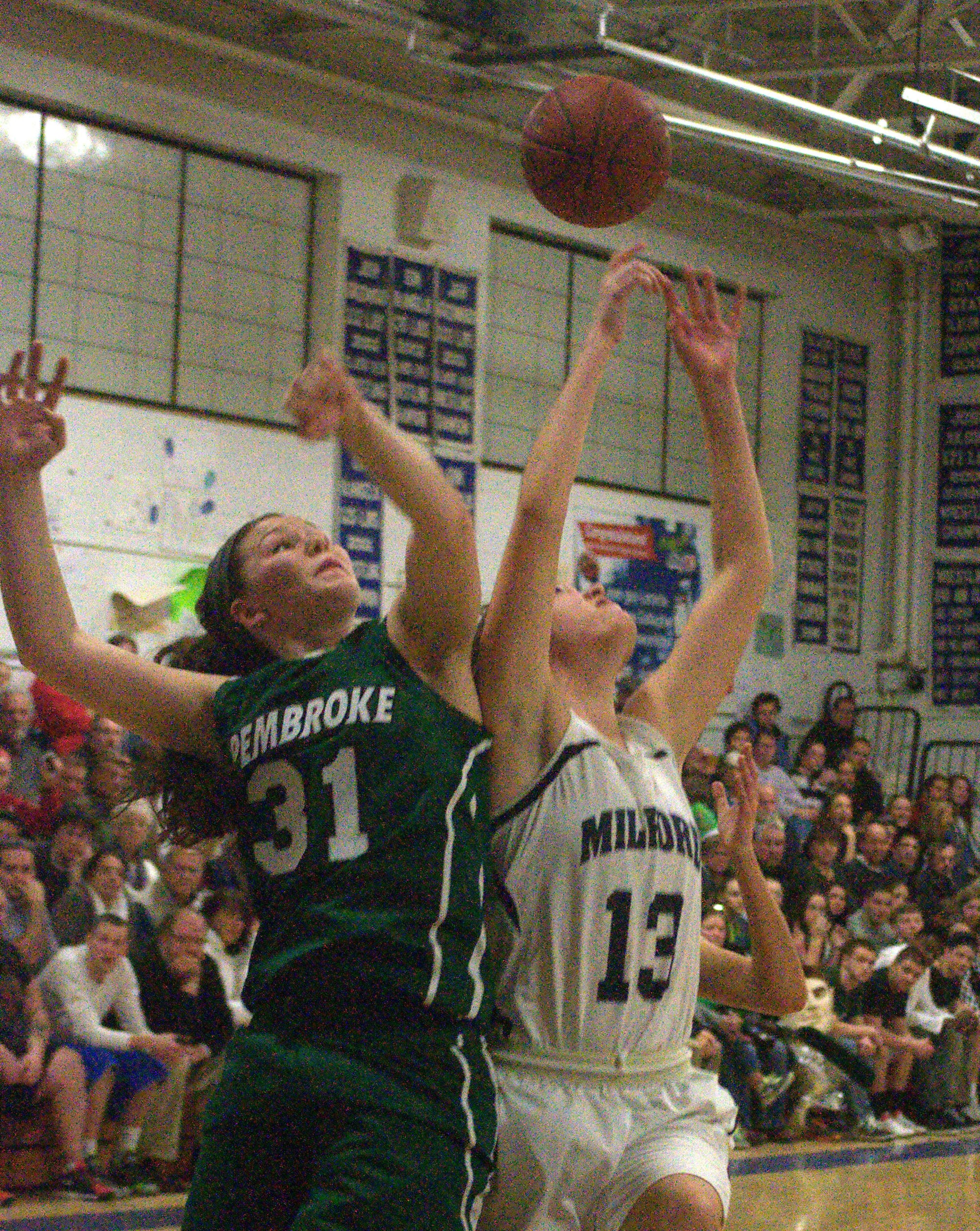 Milford's Rebecca Cleary and Pembroke's Marissa Kibbee battle for a rebound during Friday's game.