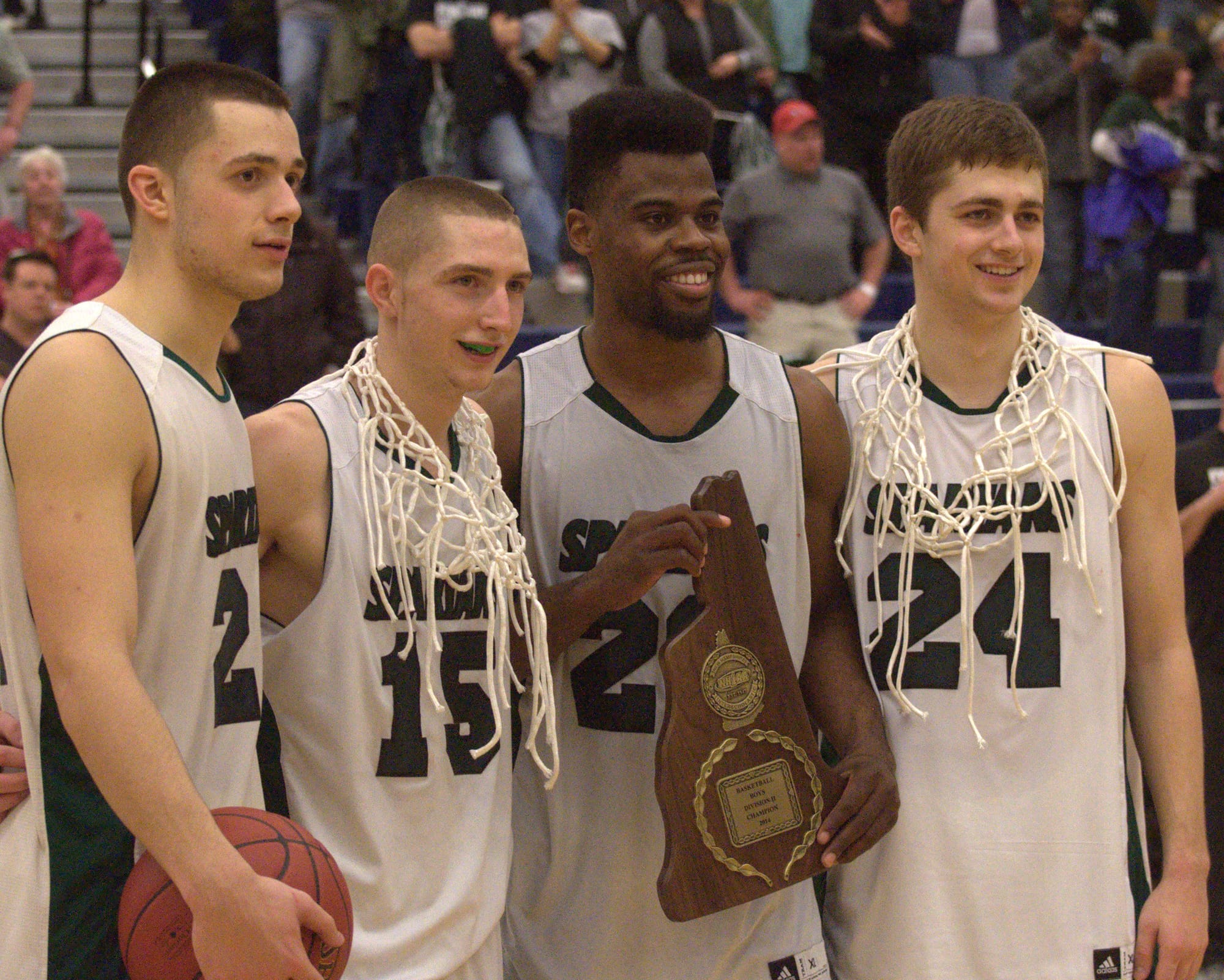 From left, Pembroke's Domonic Timbas, Pat Welch, Kafani Williams and Cameron Taylor pose with the Division II championship plaque.