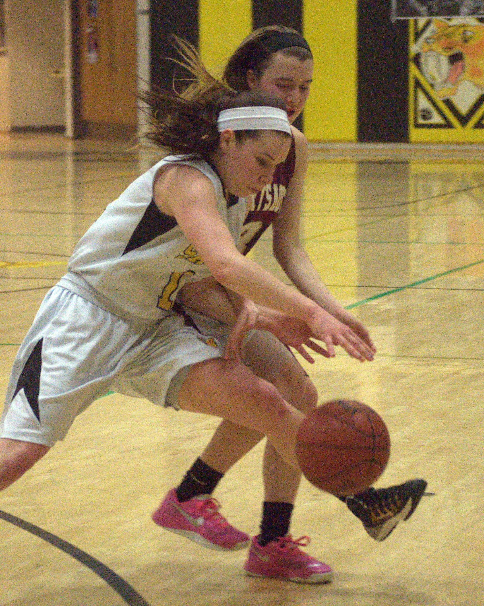 Souhegan's Morgan Brady and Portsmouth's Izzy Pafford chase after a loose ball during Friday's game.