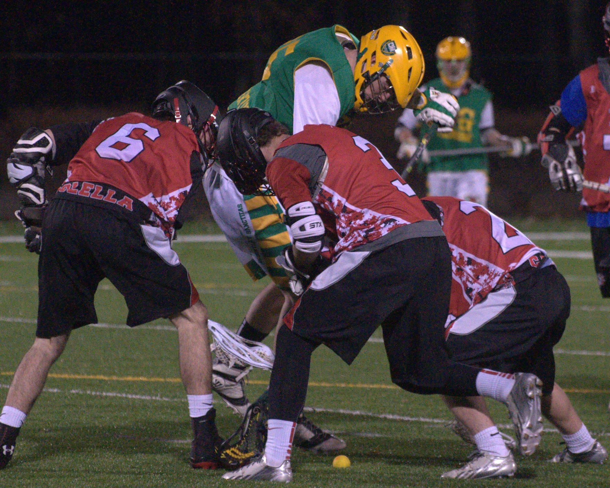 Bedford players battle for a ground ball with a Bishop Guertin player during Wednesday's scrimmage.