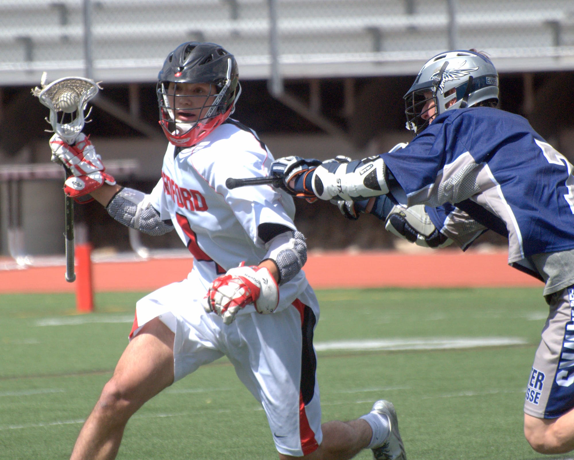Bedford's Nicholas Vailas makes his way around Exeter's Dalton Litzelman during Saturday's game.