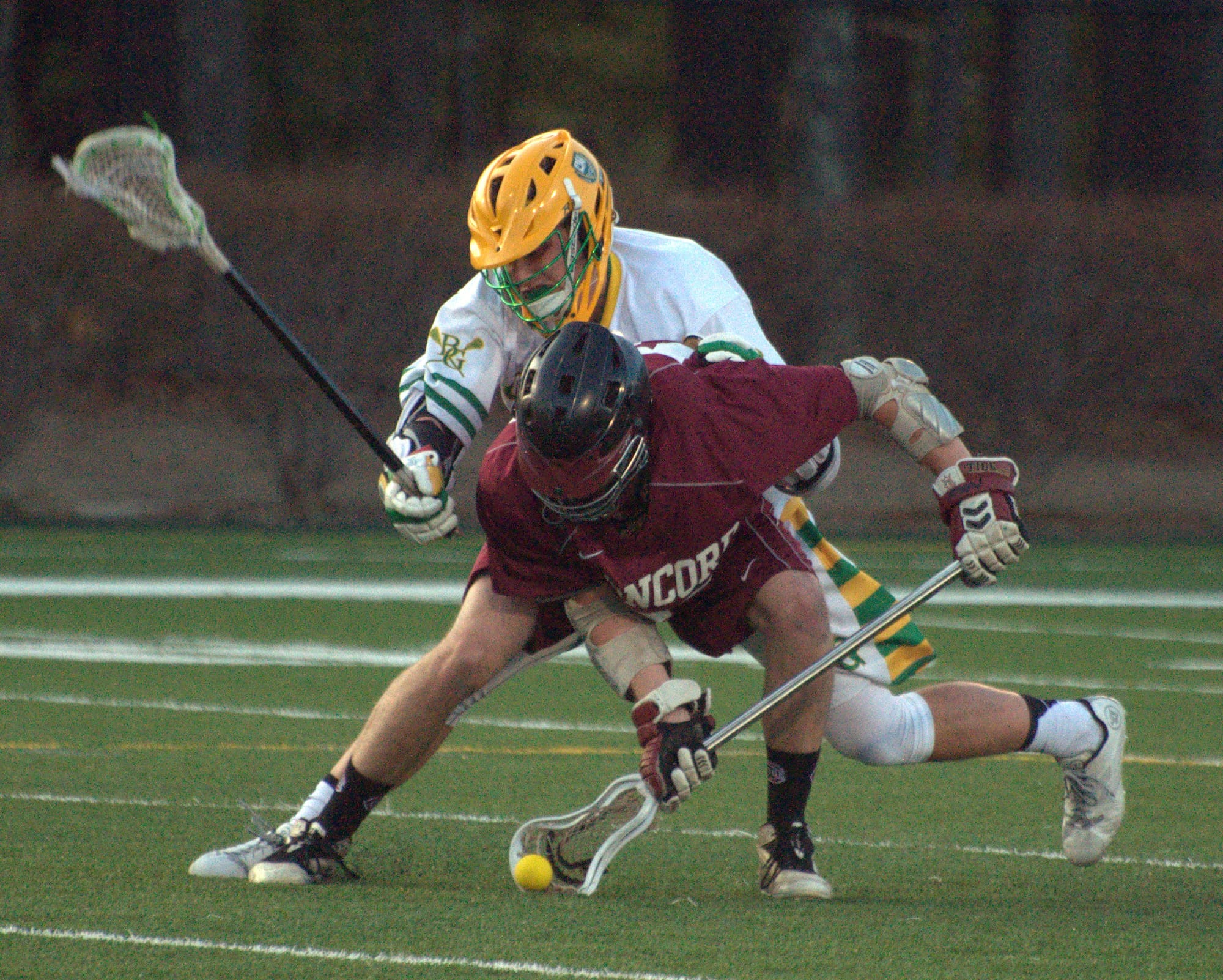 Concord's Tim Weinhold scoops a ground ball in front of Bishop Guertin's Tom Hurley during Monday's game.