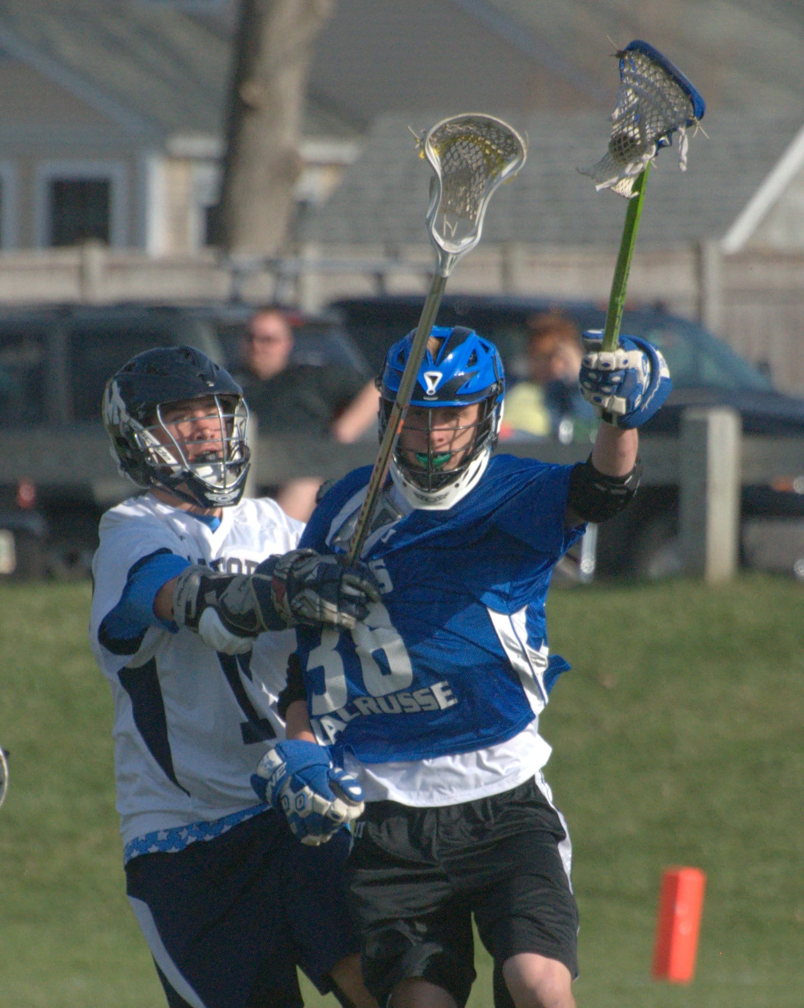 Milford's Harrison Urda tries to slow down Hollis Brookline's Mike Buxbaum.
