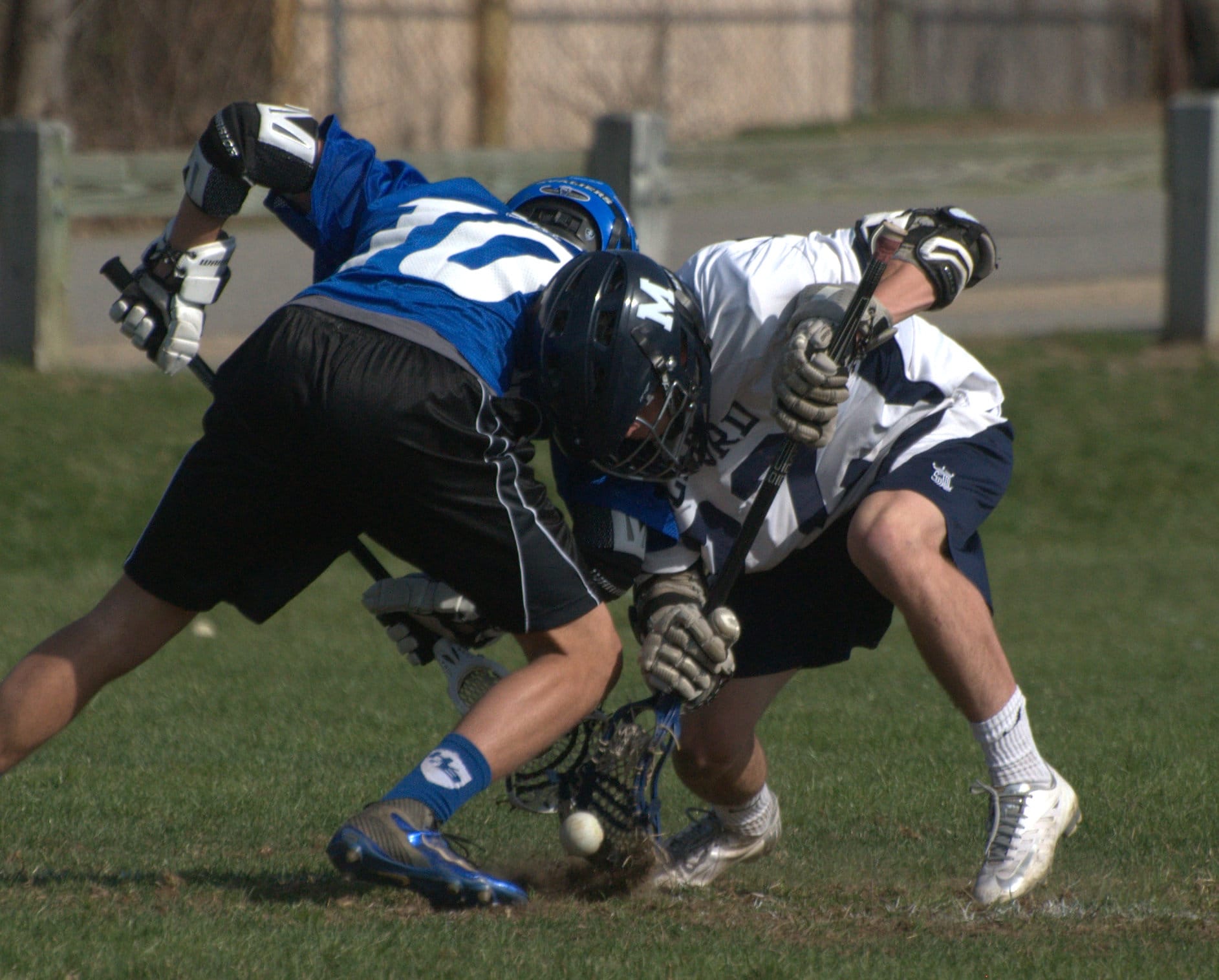 Hollis Brookline's Kevin Delaney and Milford's Max Urda battle on a faceoff.