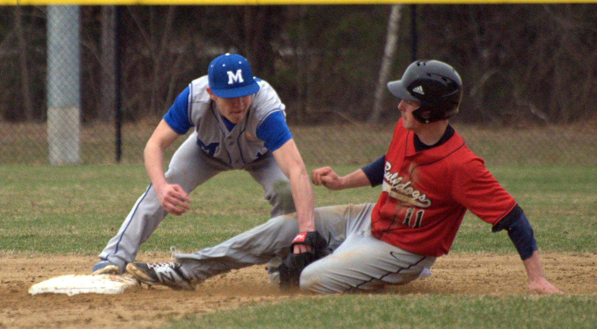 Merrimack's Chad Seaver tags out Bedford's Nick Angelini as he tries to steal second during Friday's game.