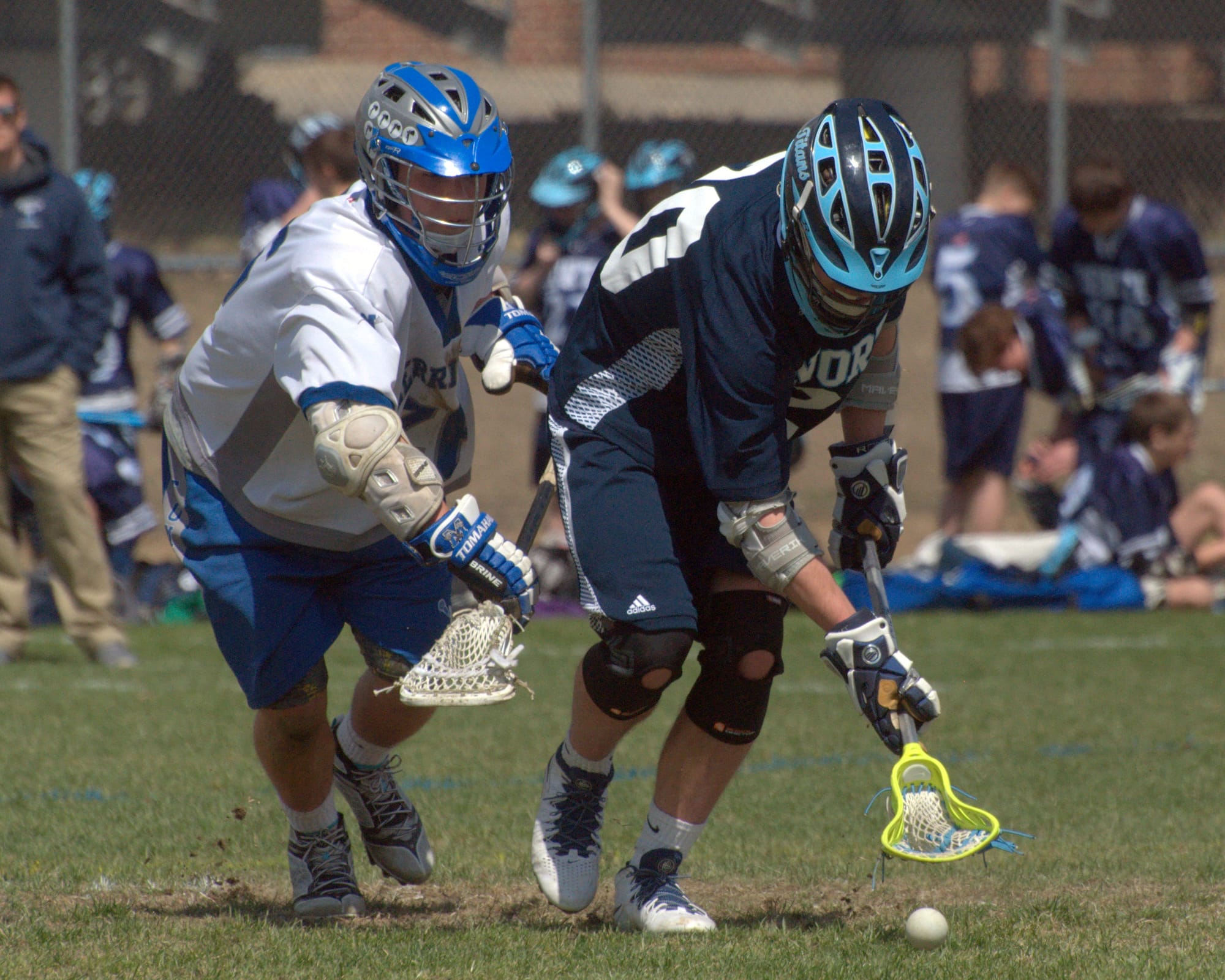 Nashua North's Tom Haller scoops up a groundball in front of Merrimack's Matt Brewster.