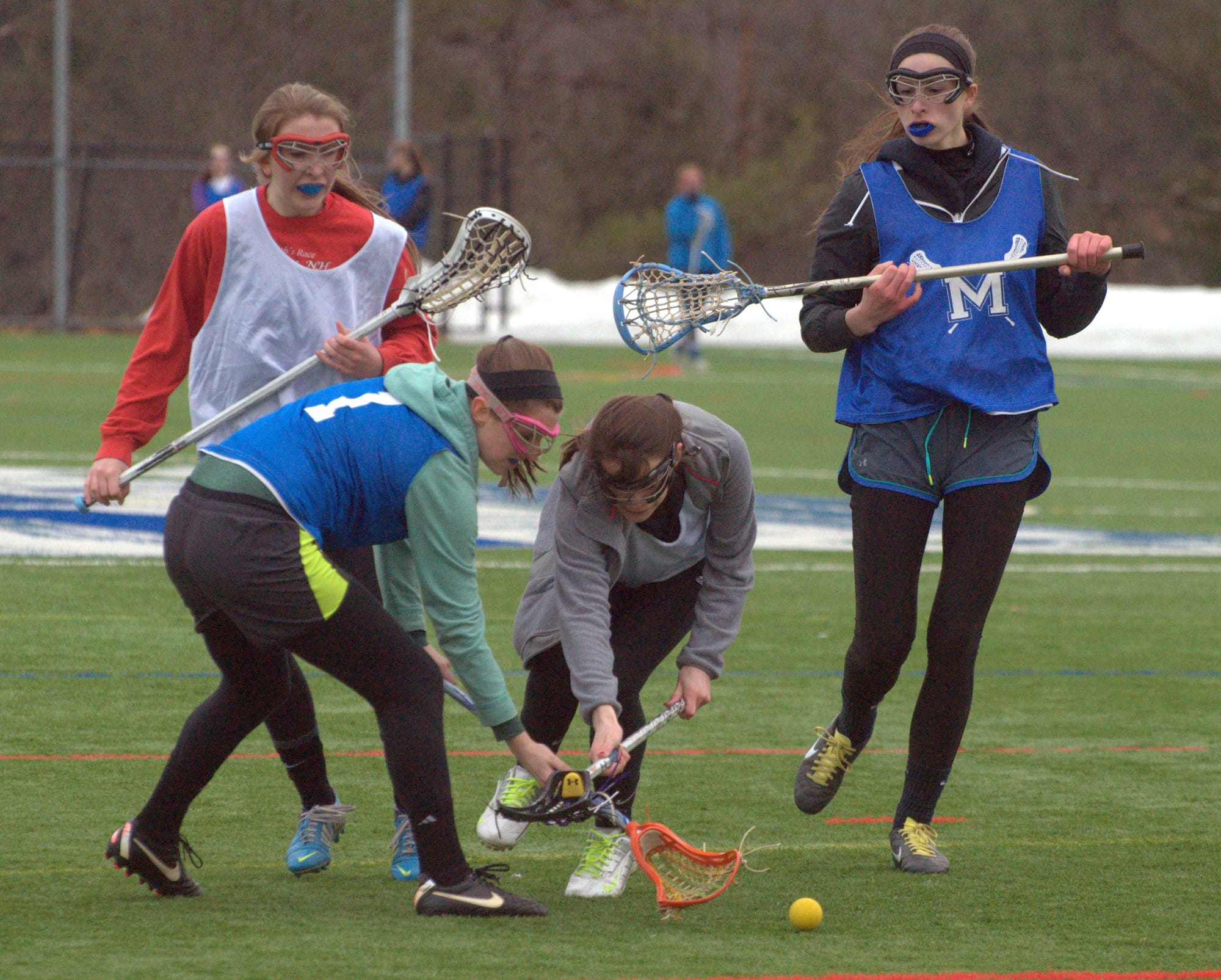 Merrimack players go after a ground ball during practice earlier this week.