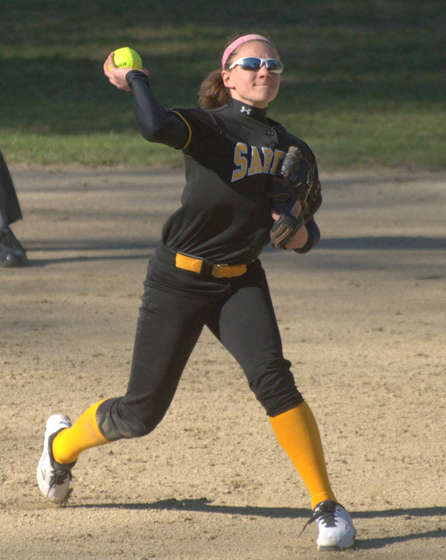 Souhegan's Val Mukai makes a throw to first base.