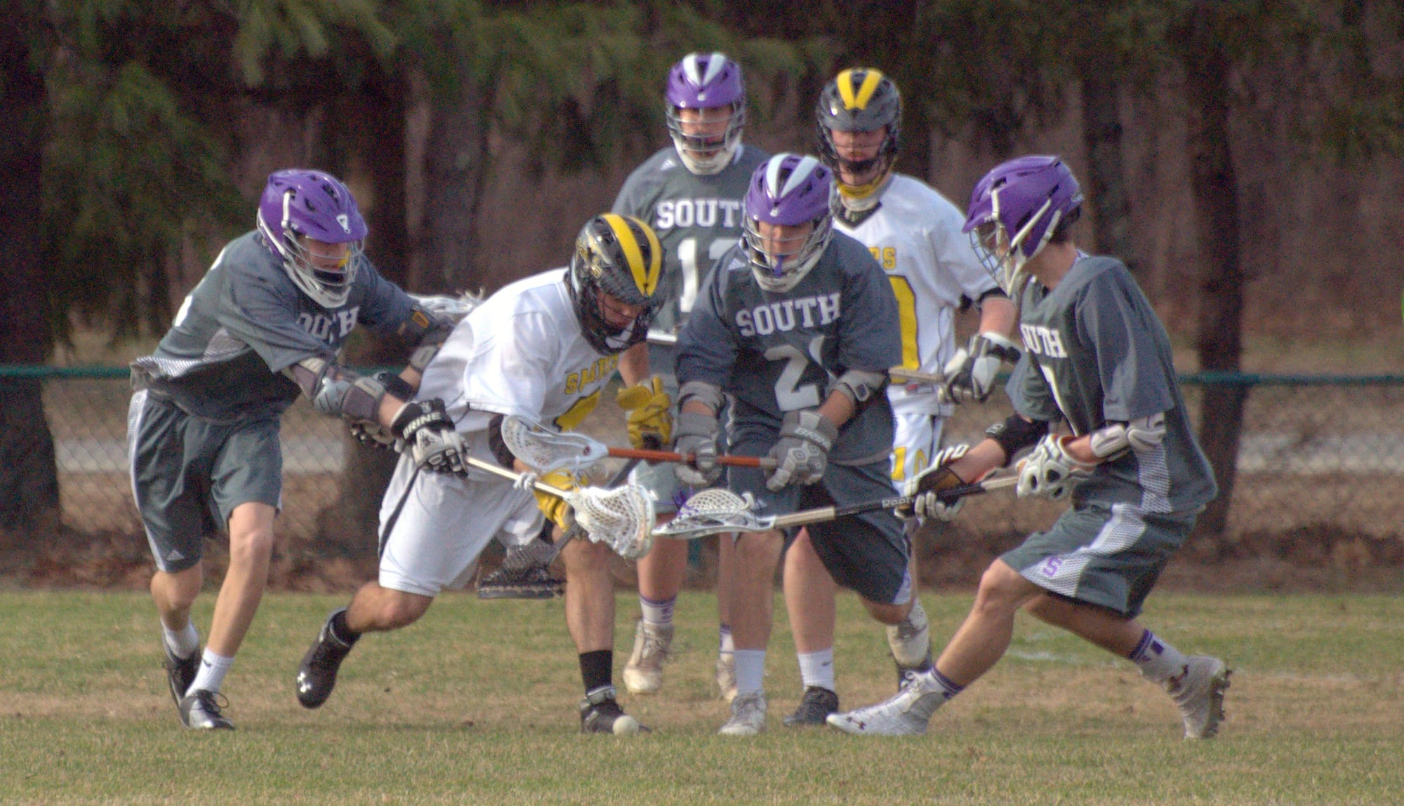 Nashua South players surround a Souhegan player as they go after a groundball during Monday's game.