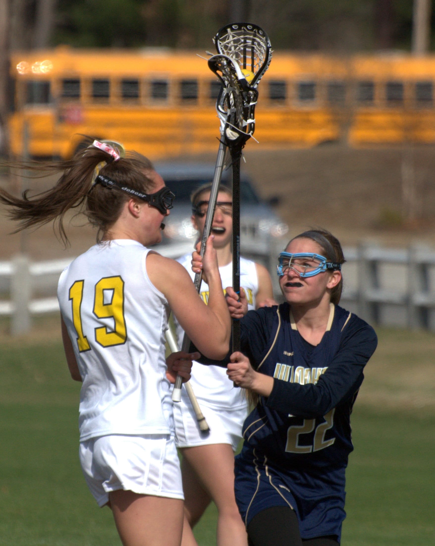 Windham's Delaney Shea tries to slow down Souhegan's Madison Learned.